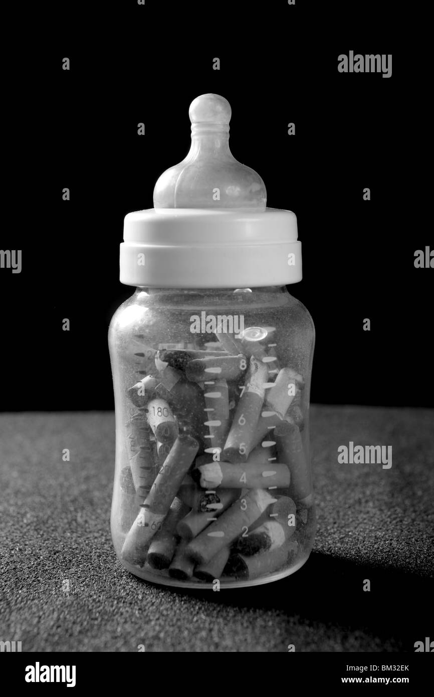 addition cigarette Tobacco addition metaphor with baby bottle full of cigarettes Stock Photo
