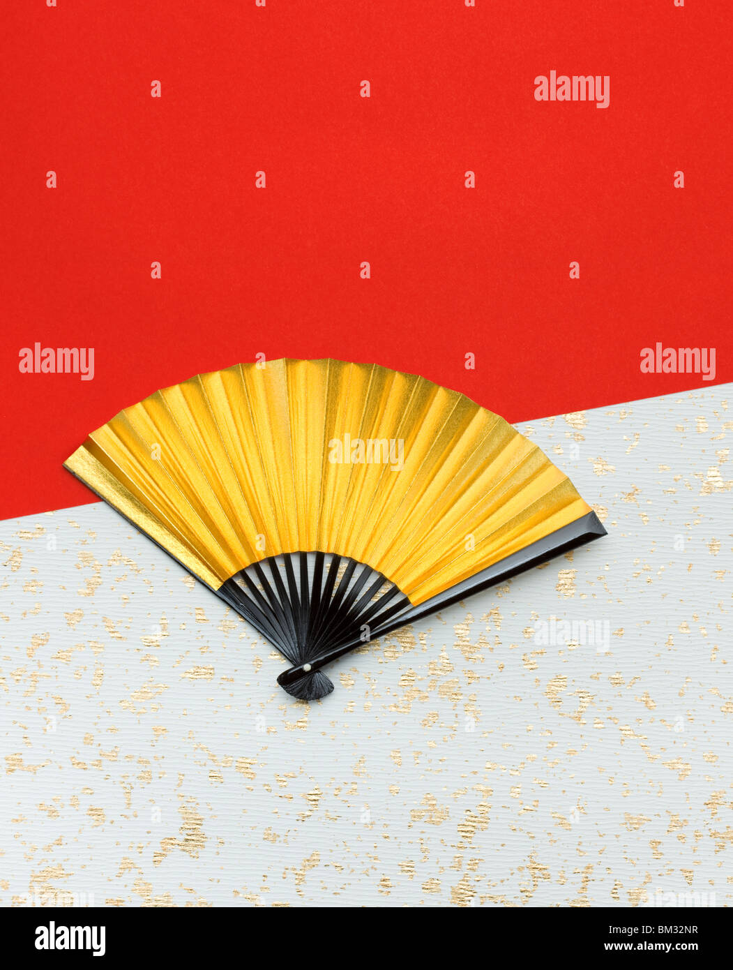 Gold folding fan on Japanese paper Stock Photo Alamy