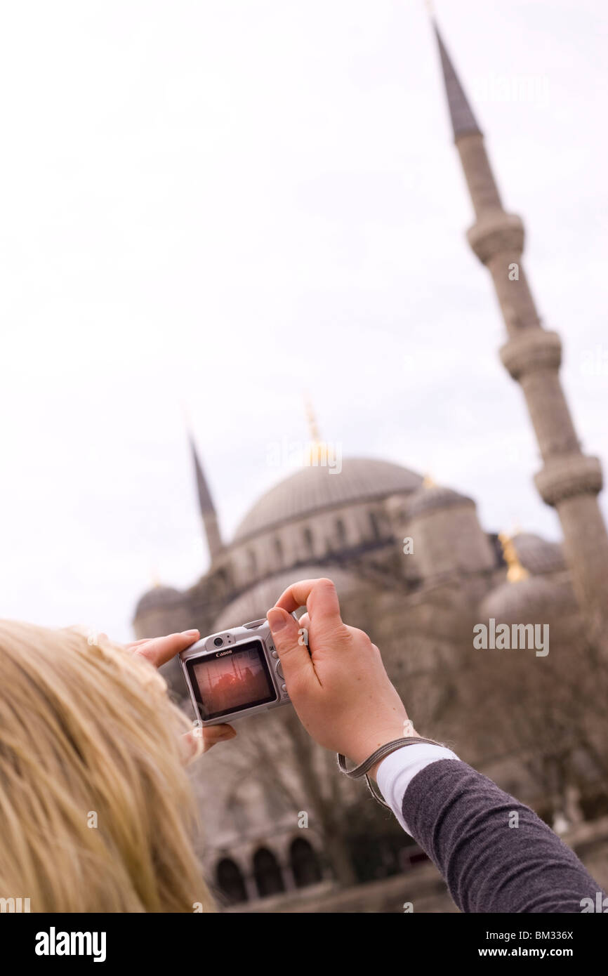Female tourist taking a photo of the Blue Mosque in Istanbul Stock Photo