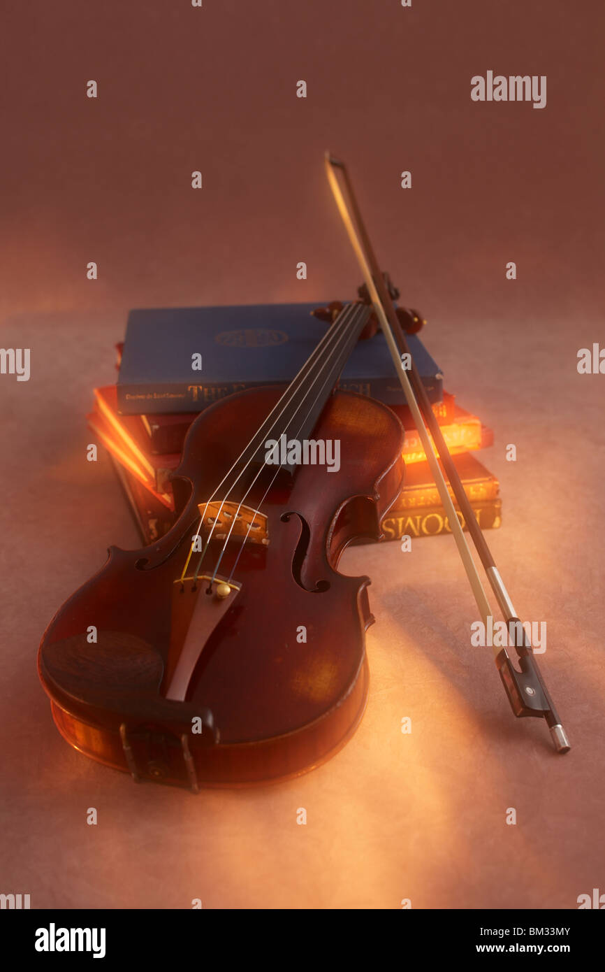 Violin and bow on books Stock Photo