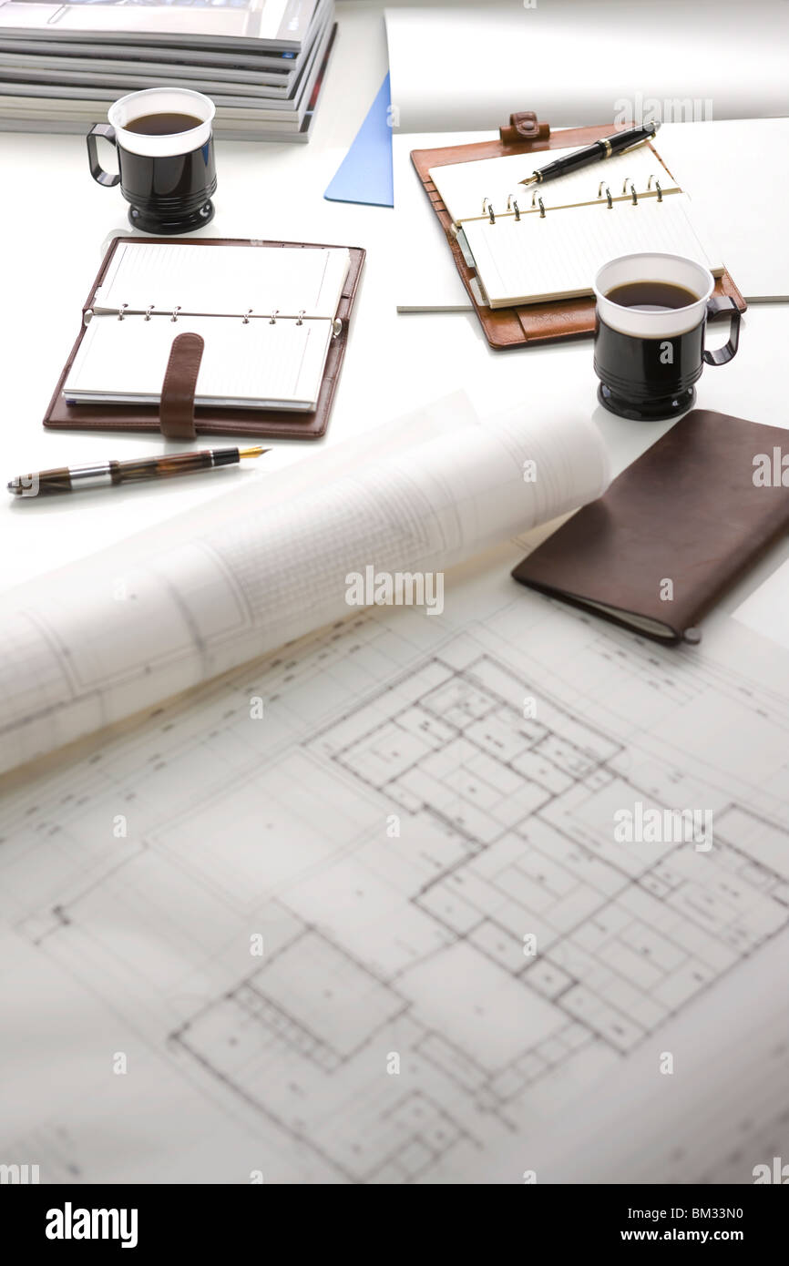 Blueprint, coffee and diary on a desk Stock Photo