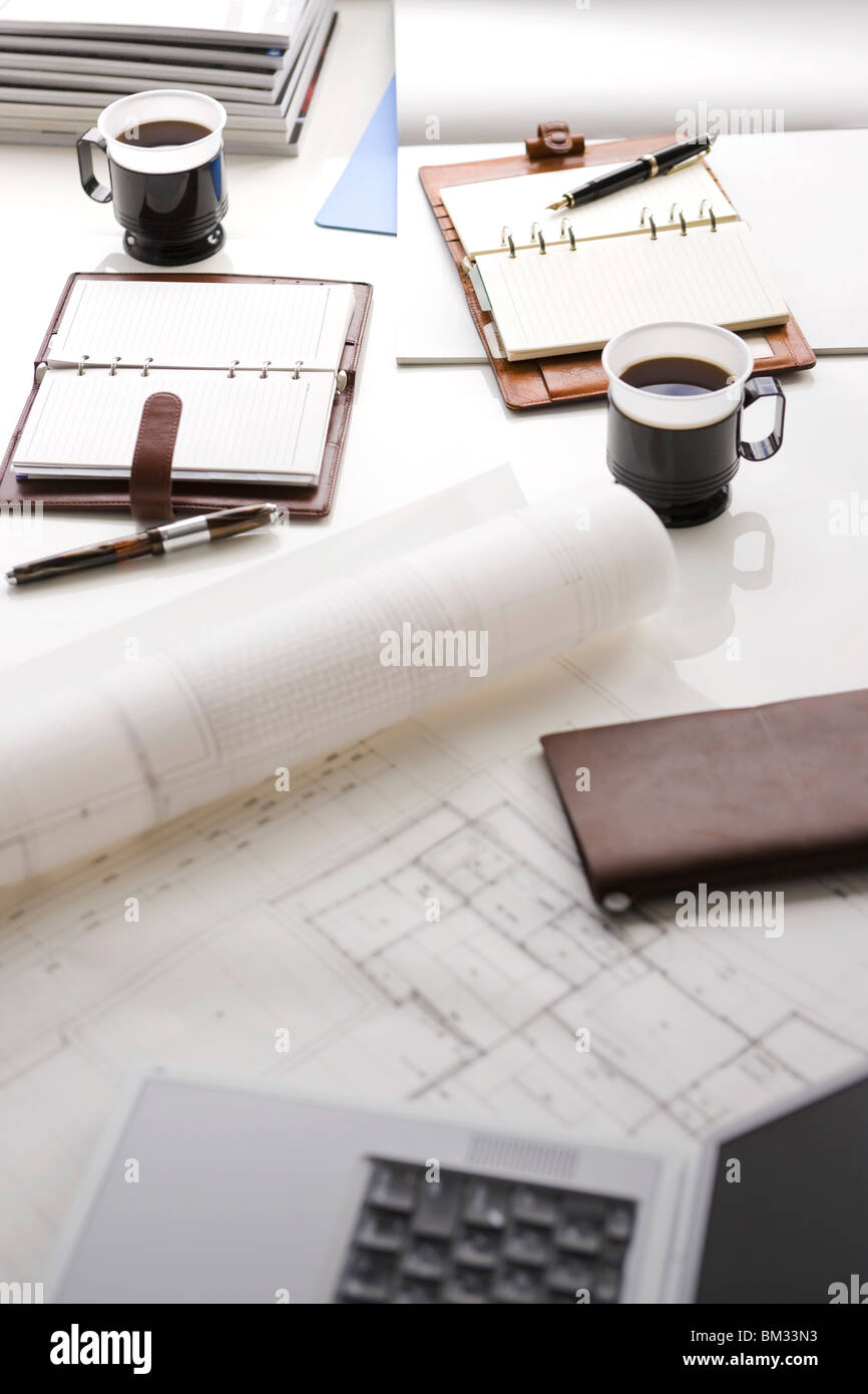 Blueprint, coffee and diary on a desk Stock Photo