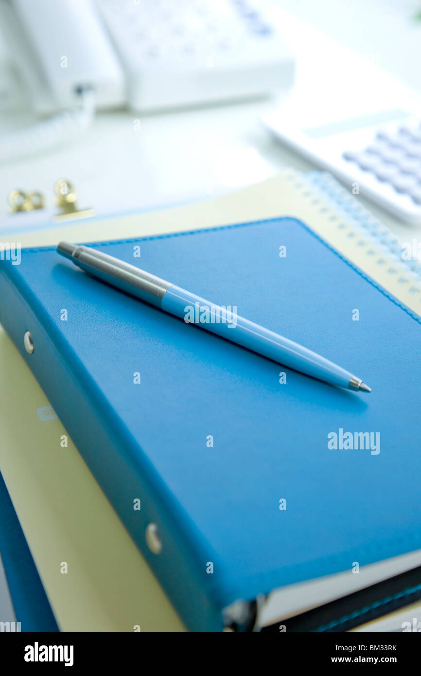 Ring binder, note pad and ballpoint pen Stock Photo