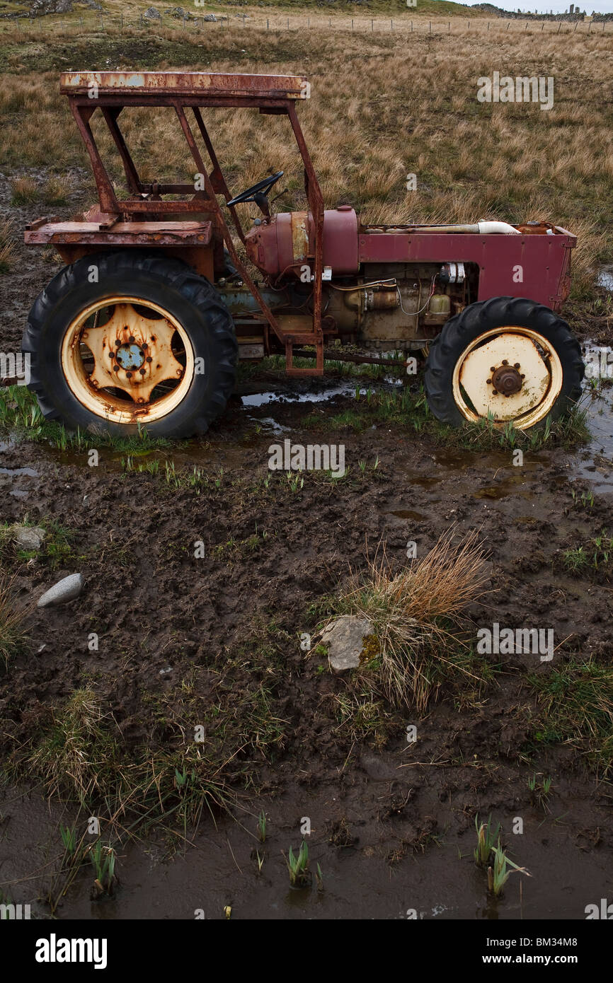 Abandoned tractor in a muddy field Stock Photo Alamy
