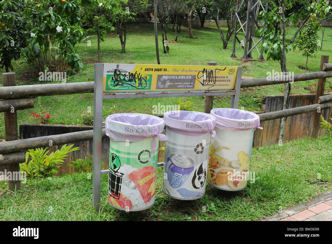 Graffiti above recycling bins in Medellin park Stock Photo - Alamy