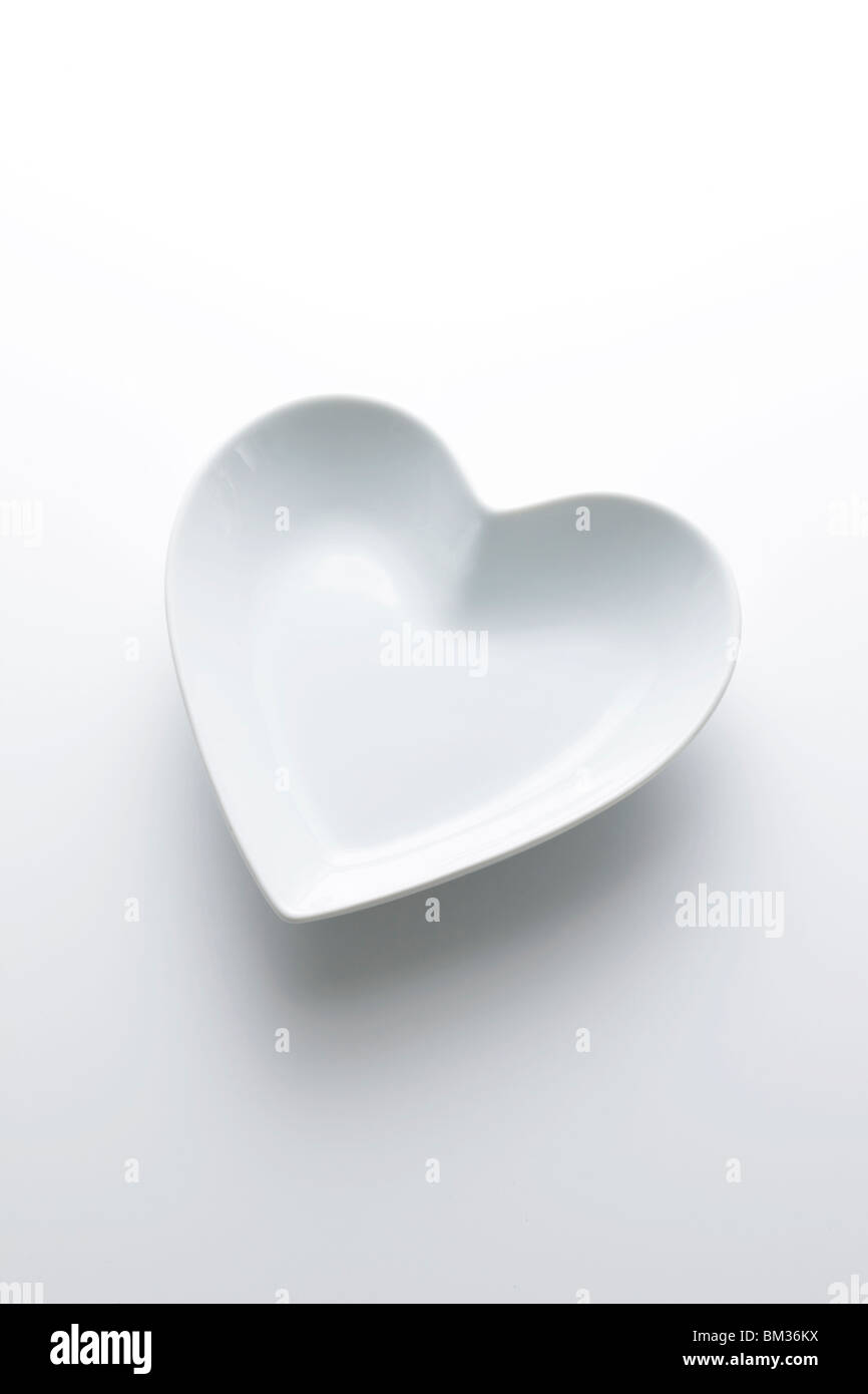 Heart shaped plate, white background Stock Photo - Alamy