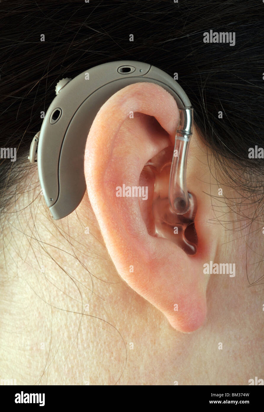 Digital hearing aid, hearing aid in a woman's ear Stock Photo
