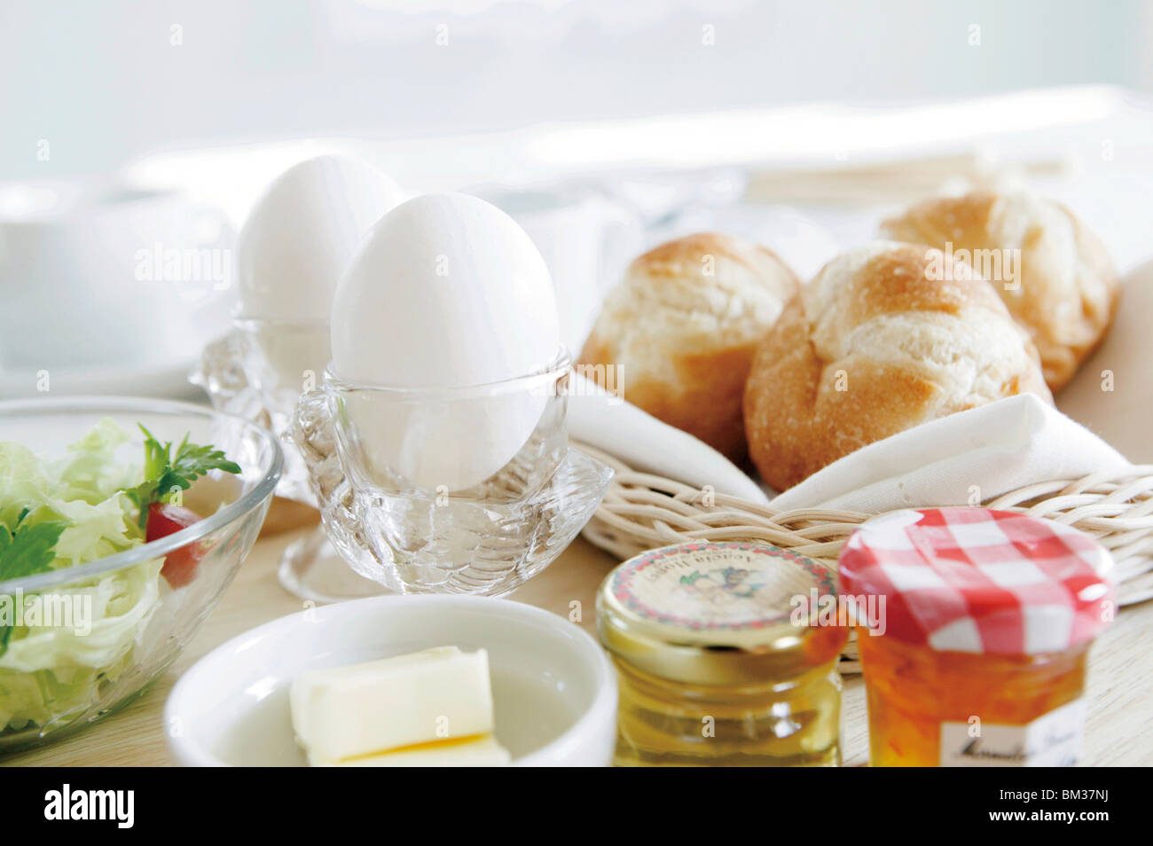 Boiled eggs and bread on table Stock Photo