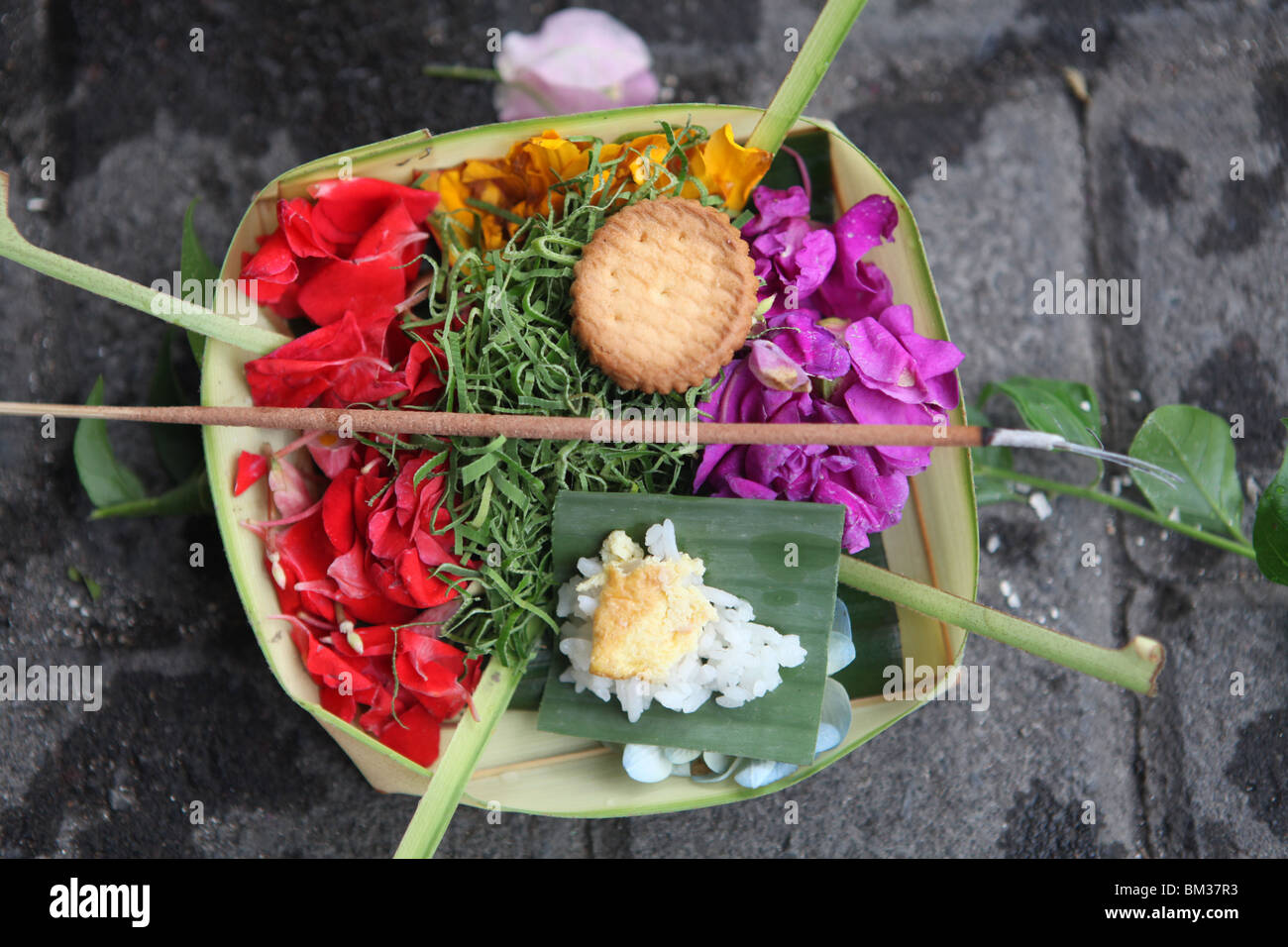 A freshly placed offering to the gods on the street in Kuta, Bali, Indonesia Stock Photo