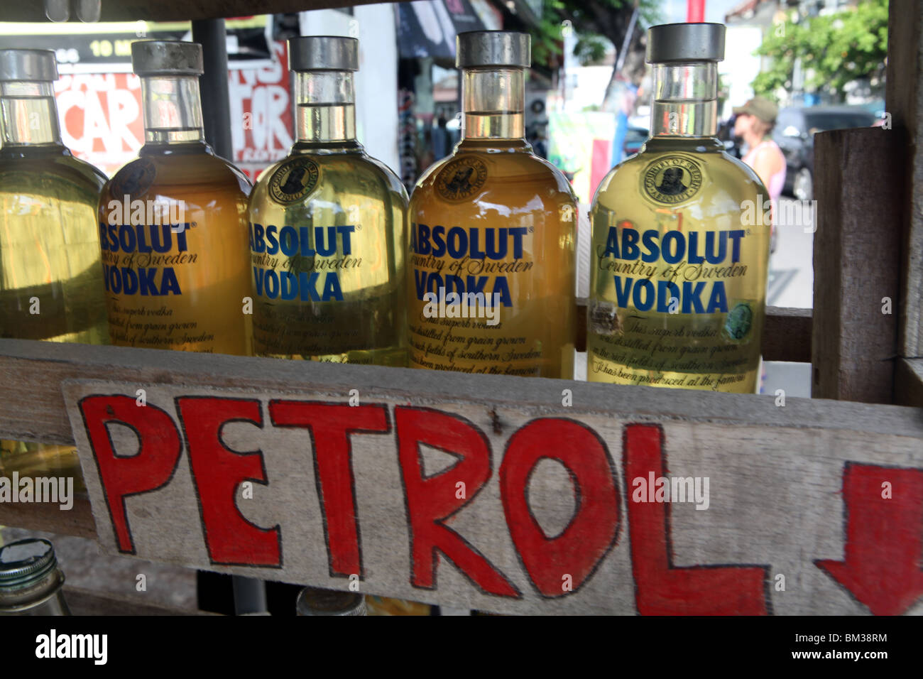 Pertol or gas, commonly stored in Absolut Vodka bottles on the street in Kuta, Bali, Indonesia Stock Photo