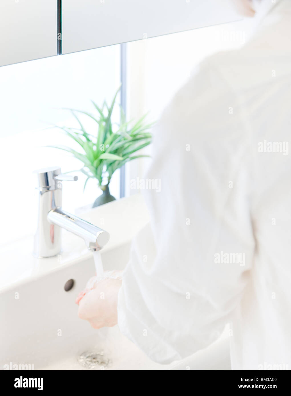 Woman washing hands Stock Photo