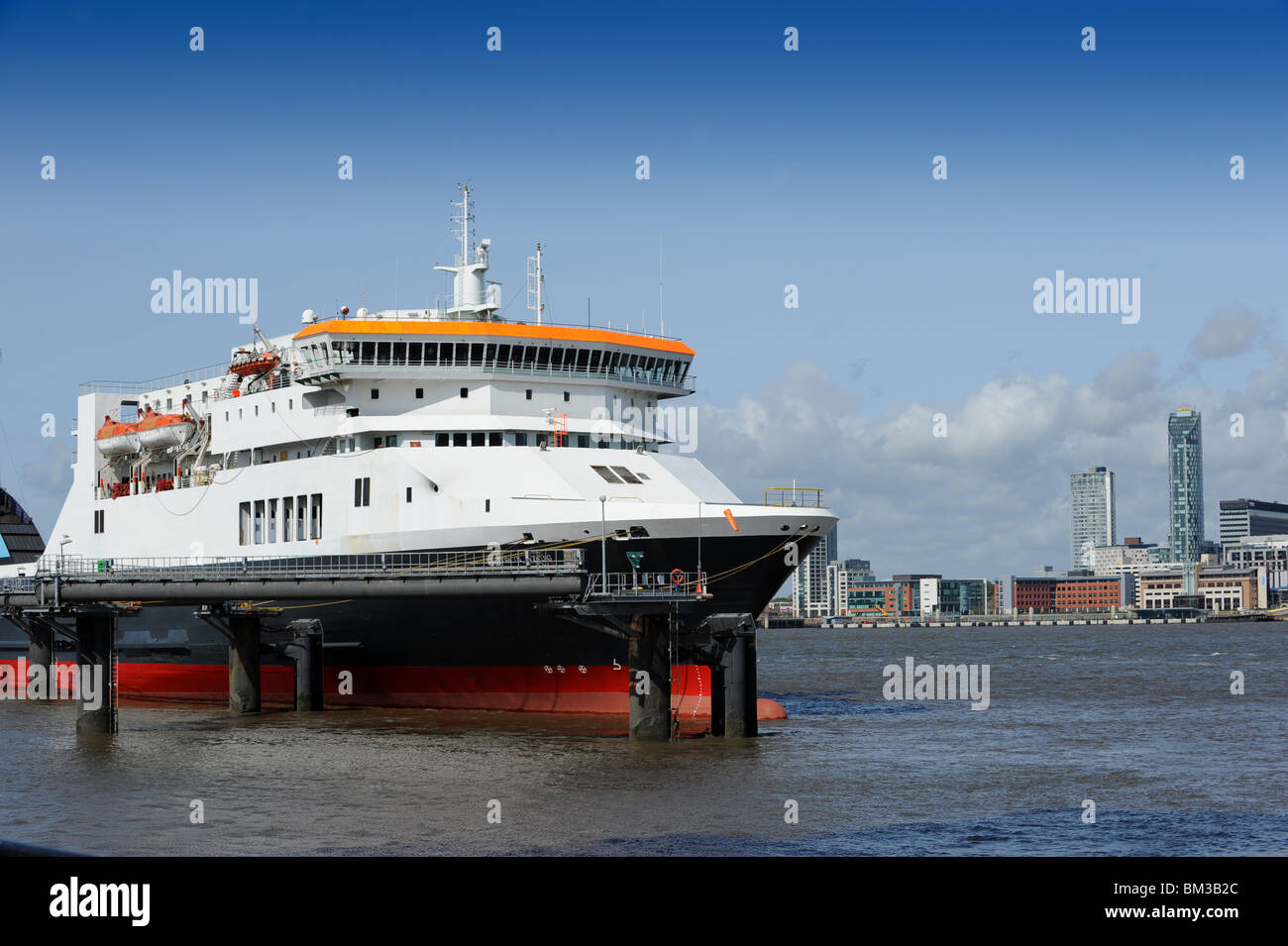 Dublin and Belfast Irish Sea Ferry moored at Birkenhead Pier on the River Mersey with Liverpool in the distance. Stock Photo