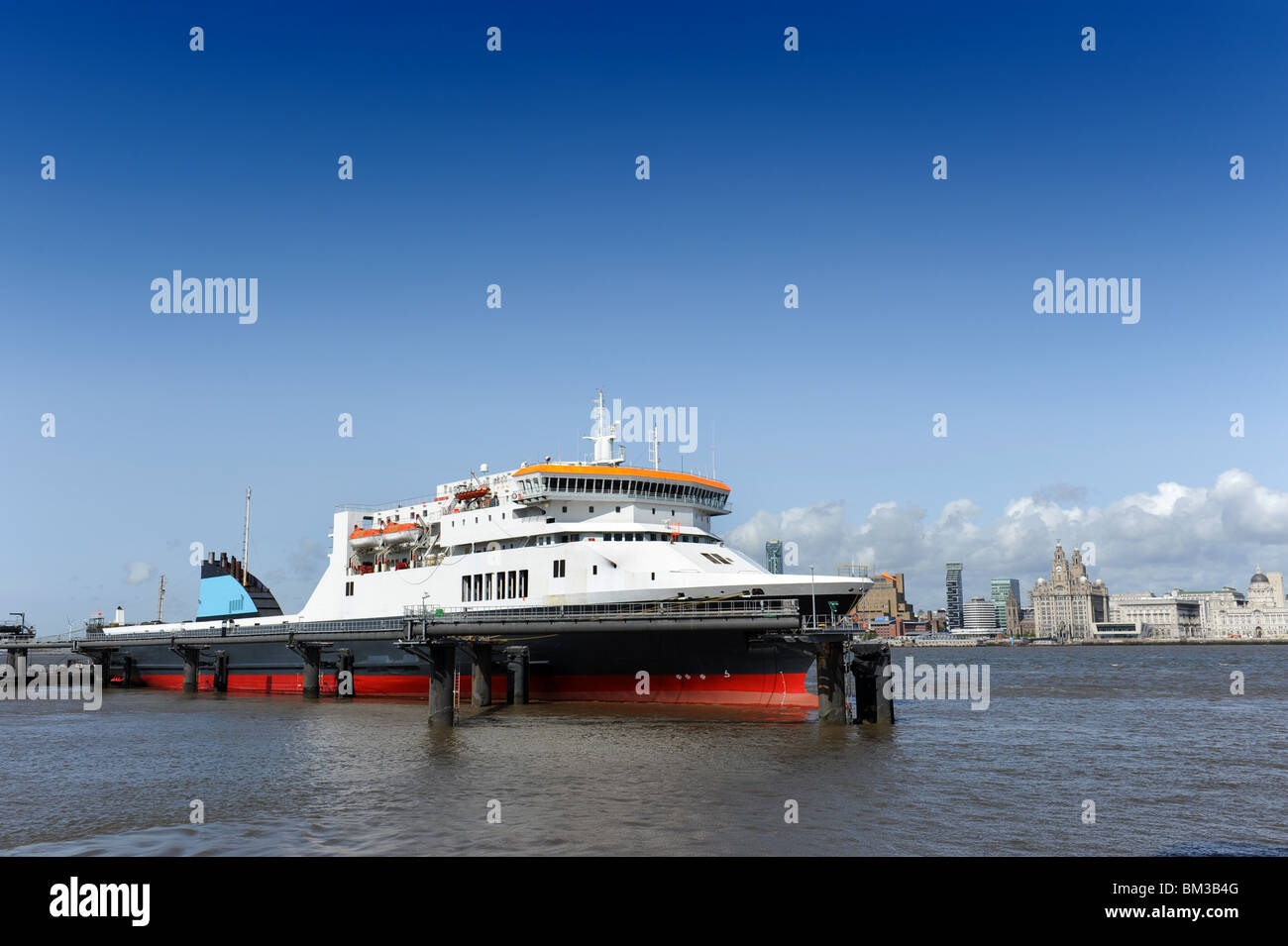 Dublin and Belfast Irish Sea Ferry moored at Birkenhead Pier on the River Mersey with Liverpool in the distance. Stock Photo