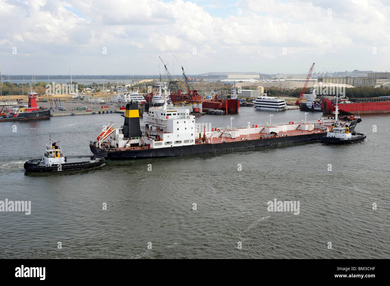 Tugboat moving barge in Tampa Bay Florida waterway harbor channel Stock Photo