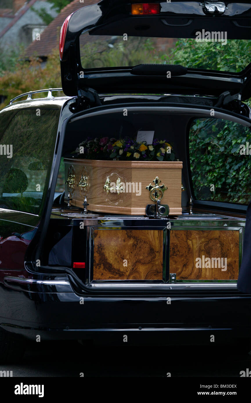 coffin in black hearse Stock Photo