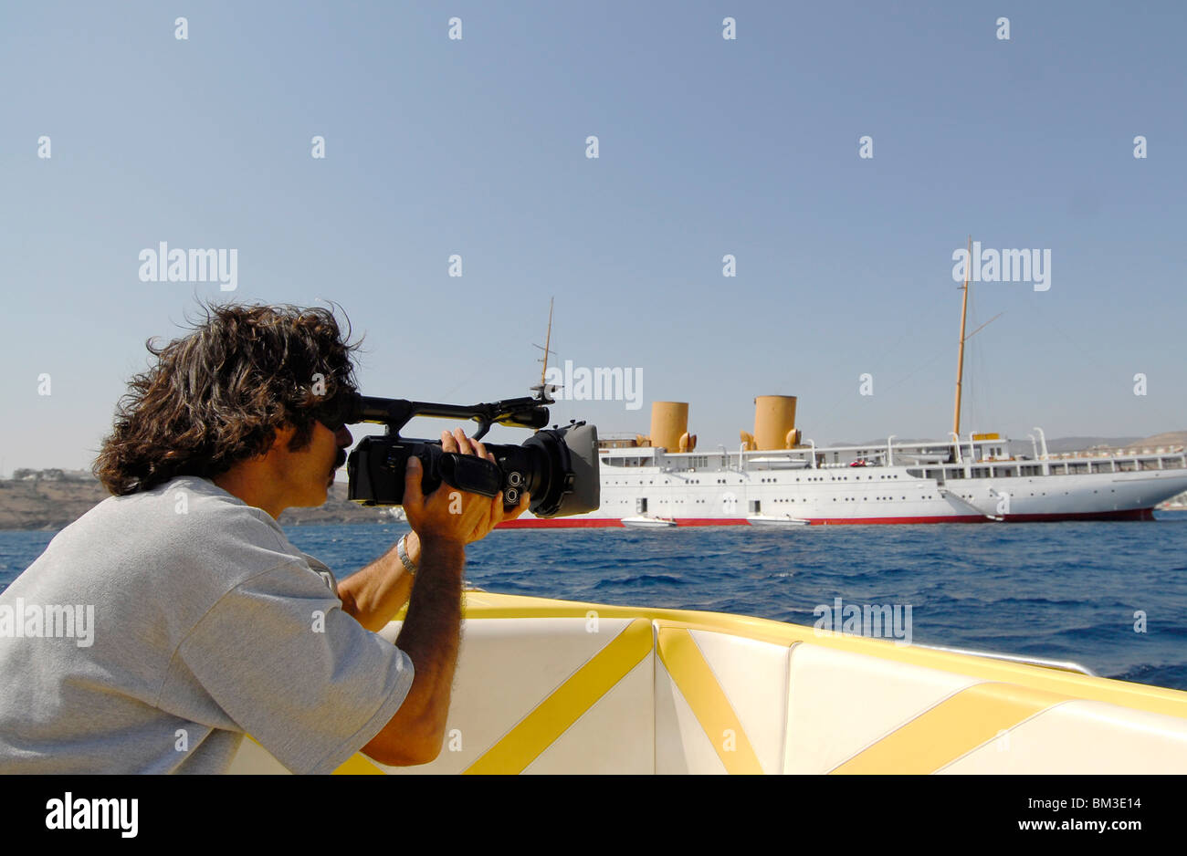 paparazzi peeping a luxury boat with camera, Stock Photo