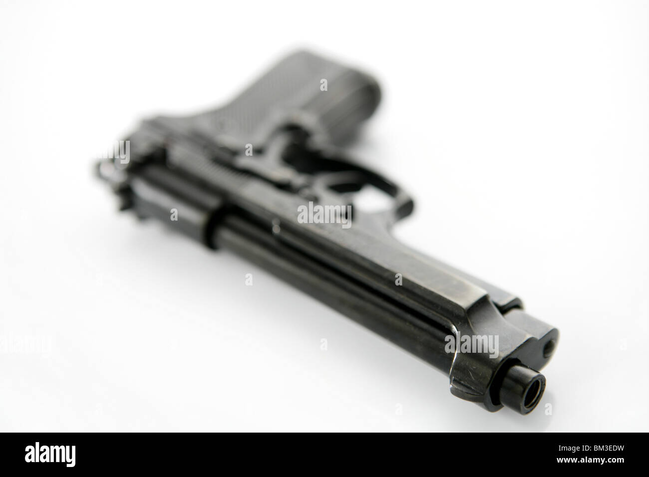black hand gun pistol over white background, selective focus, studio shot Stock Photo
