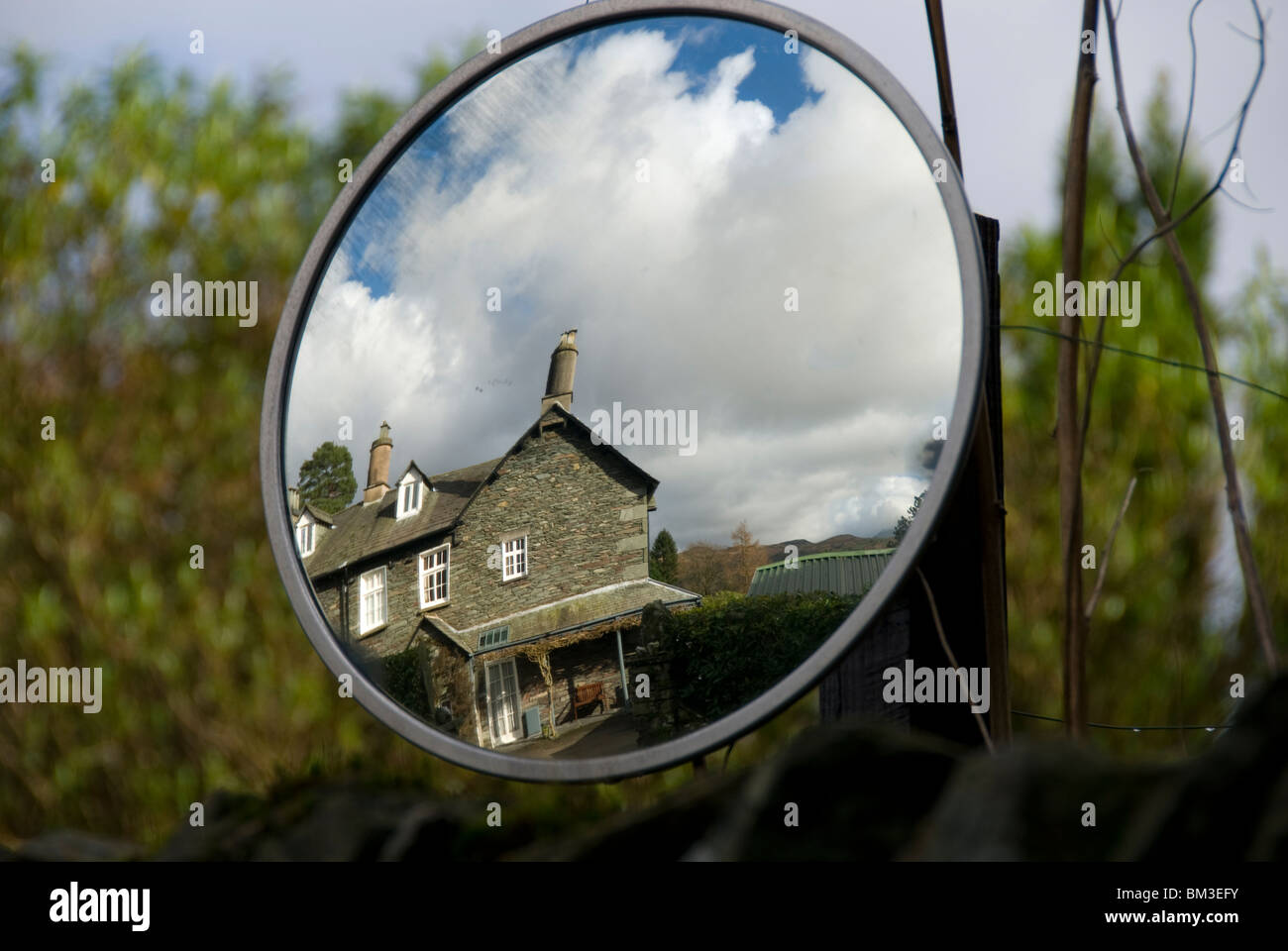 Reflection of a house in a convex traffic mirror, near Ambleside, Lake District, Cumbria England, UK Stock Photo
