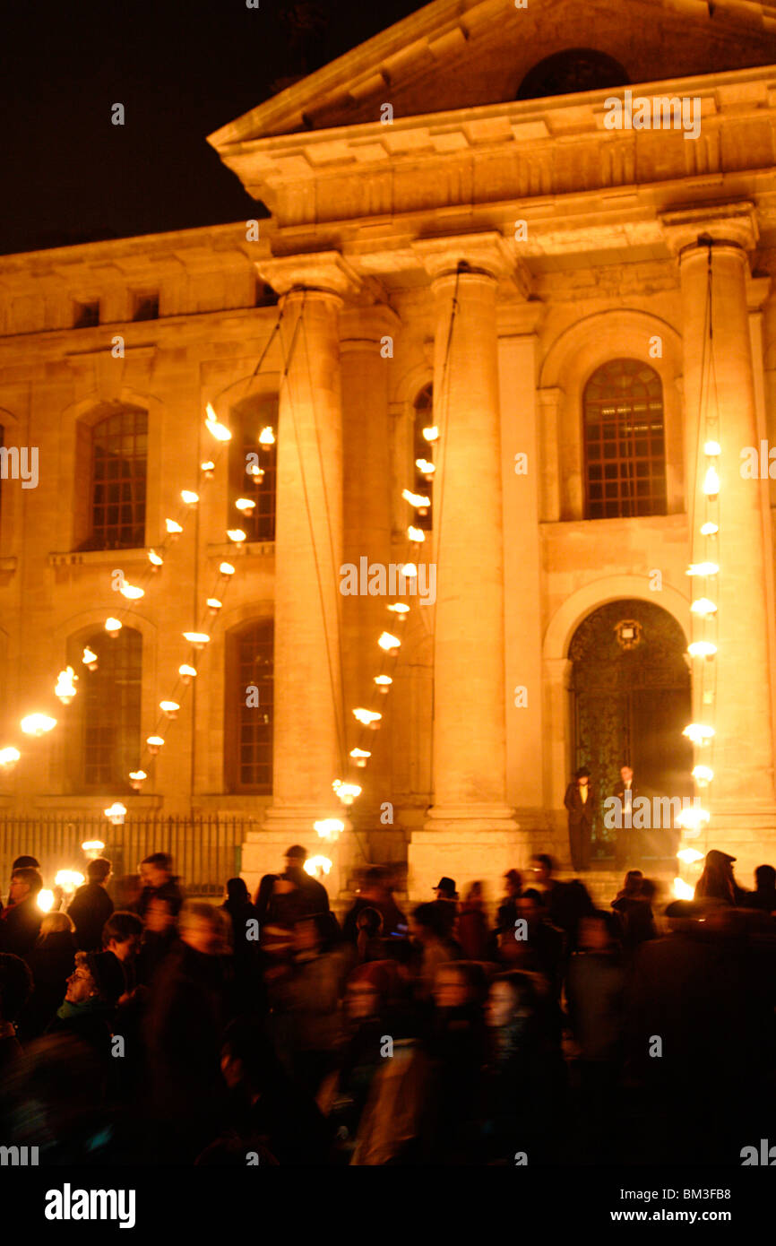 Visitors crowd Broad Street in front of illuminated Clarendon Building