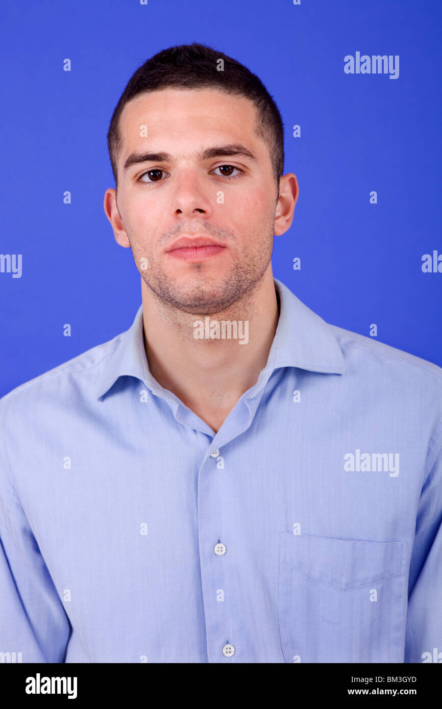 an casual young man portrait over a blue background Stock Photo - Alamy