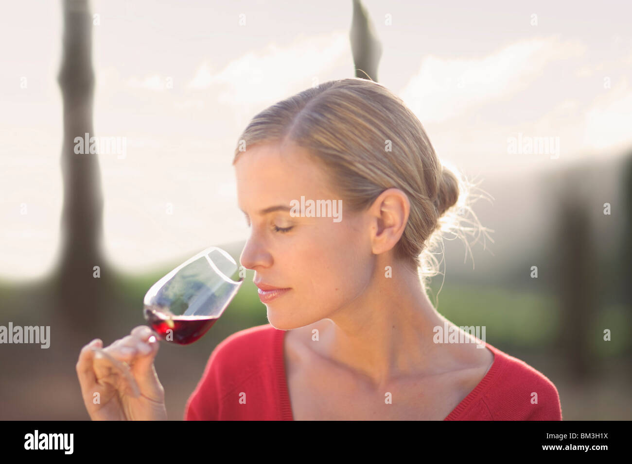 Woman enjoying a glass of red wine Stock Photo - Alamy