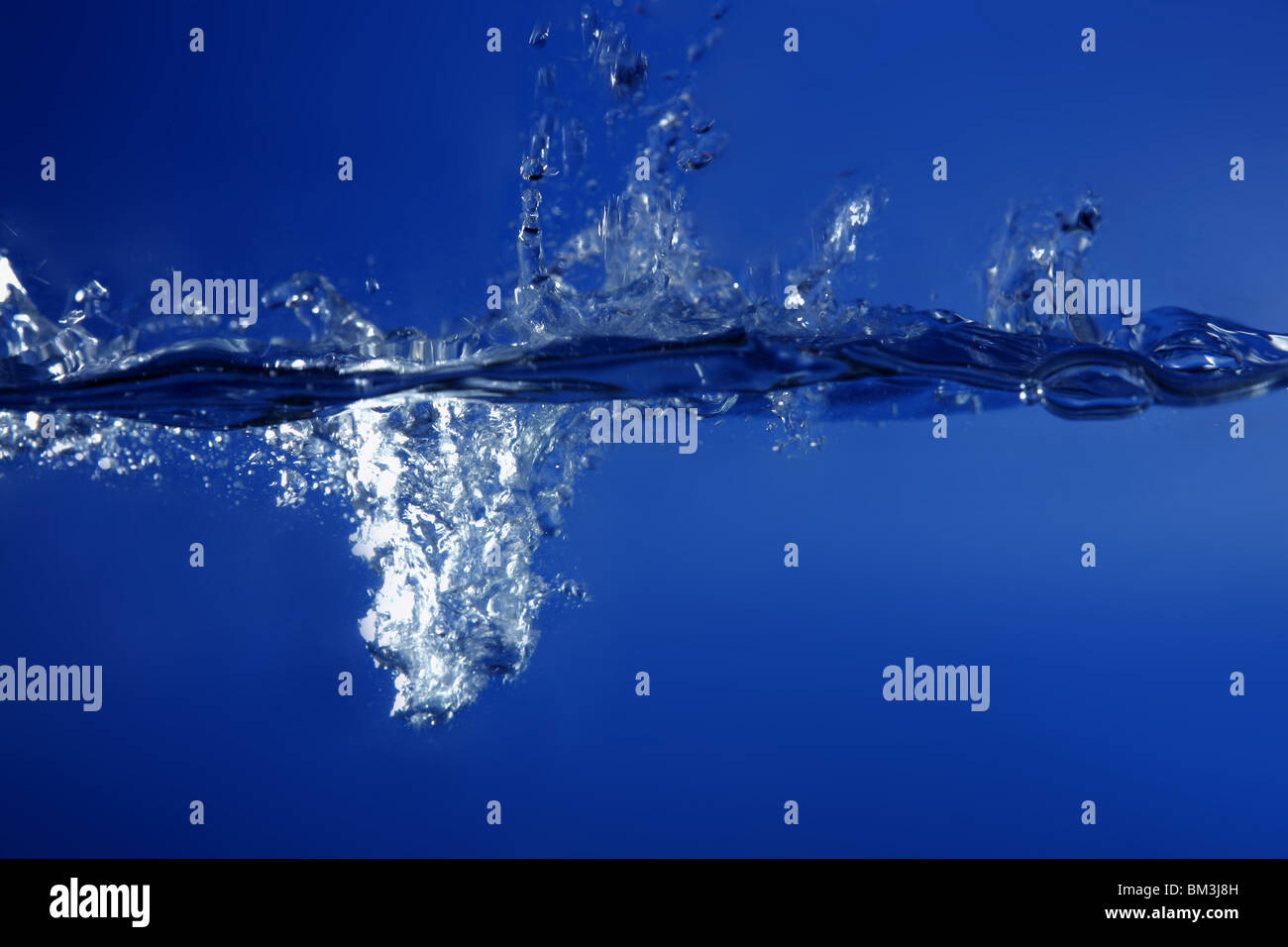 Blue water falling like splash close up macro side view Stock Photo - Alamy