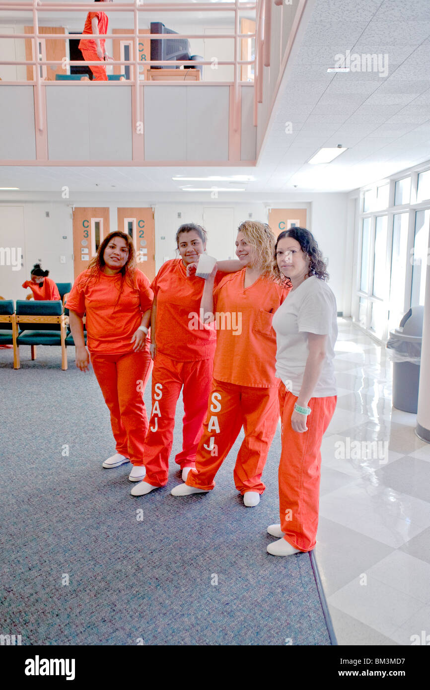 Hispanic inmates gather in the Womens Unit day room of the Santa Ana, California, City Jail. Note orange uniforms. Stock Photo