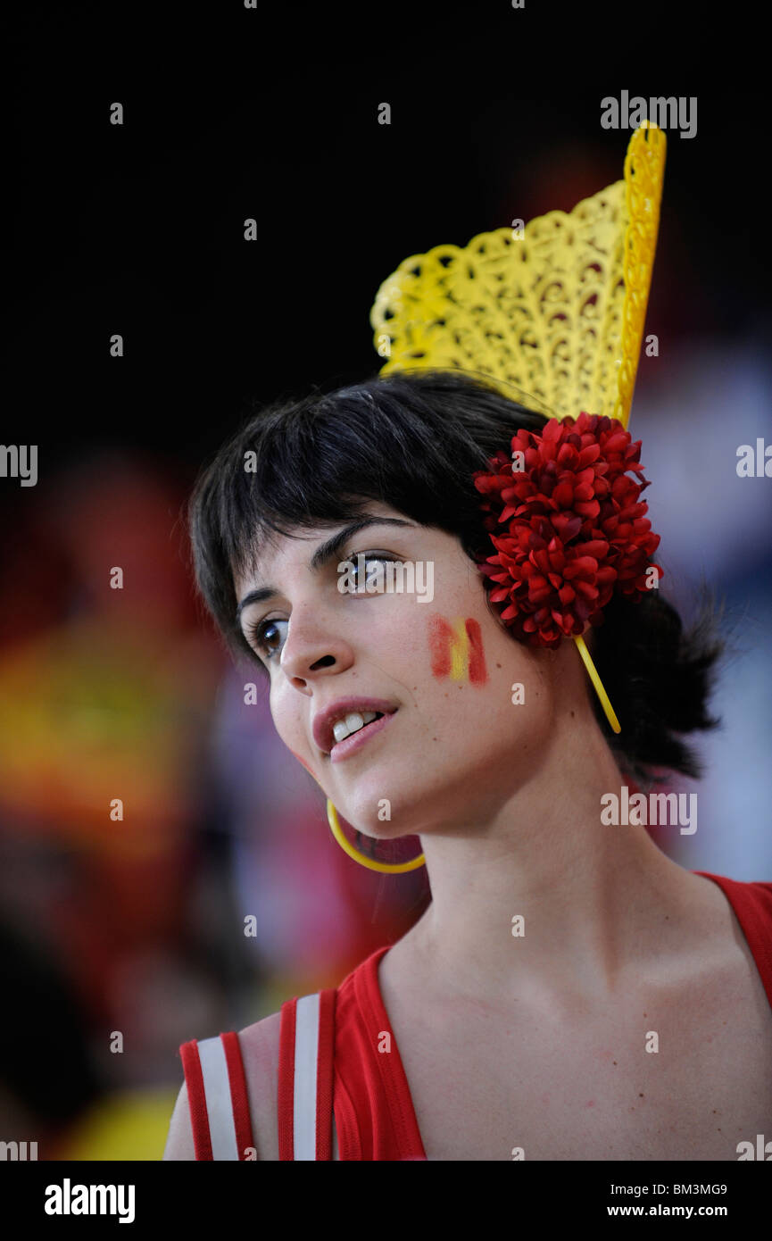 Young lady from Spain, she is a football fan of his national team. She is dressed in yellow and red, the colors of the Spain Stock Photo