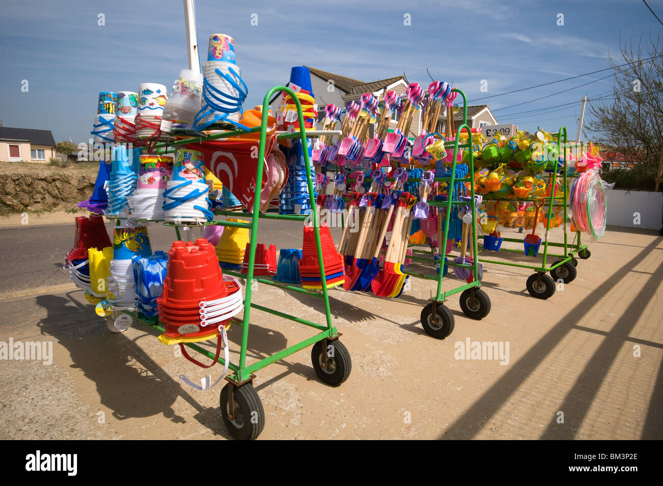 beach goods and toys for sale in racks at shop Camber Sands Beach in East Sussex england uk Stock Photo