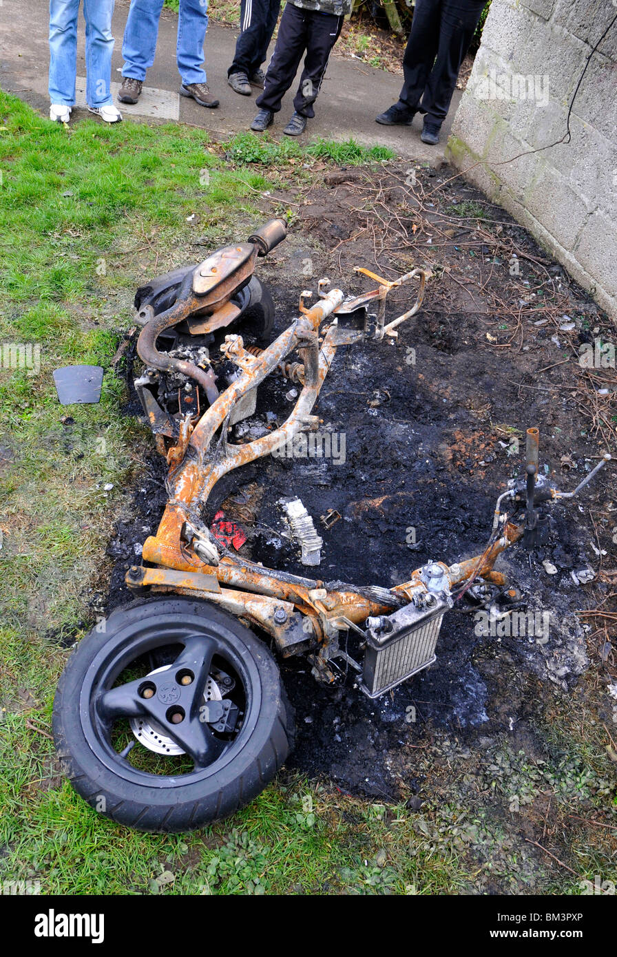 Burnt out motor scooter Stock Photo
