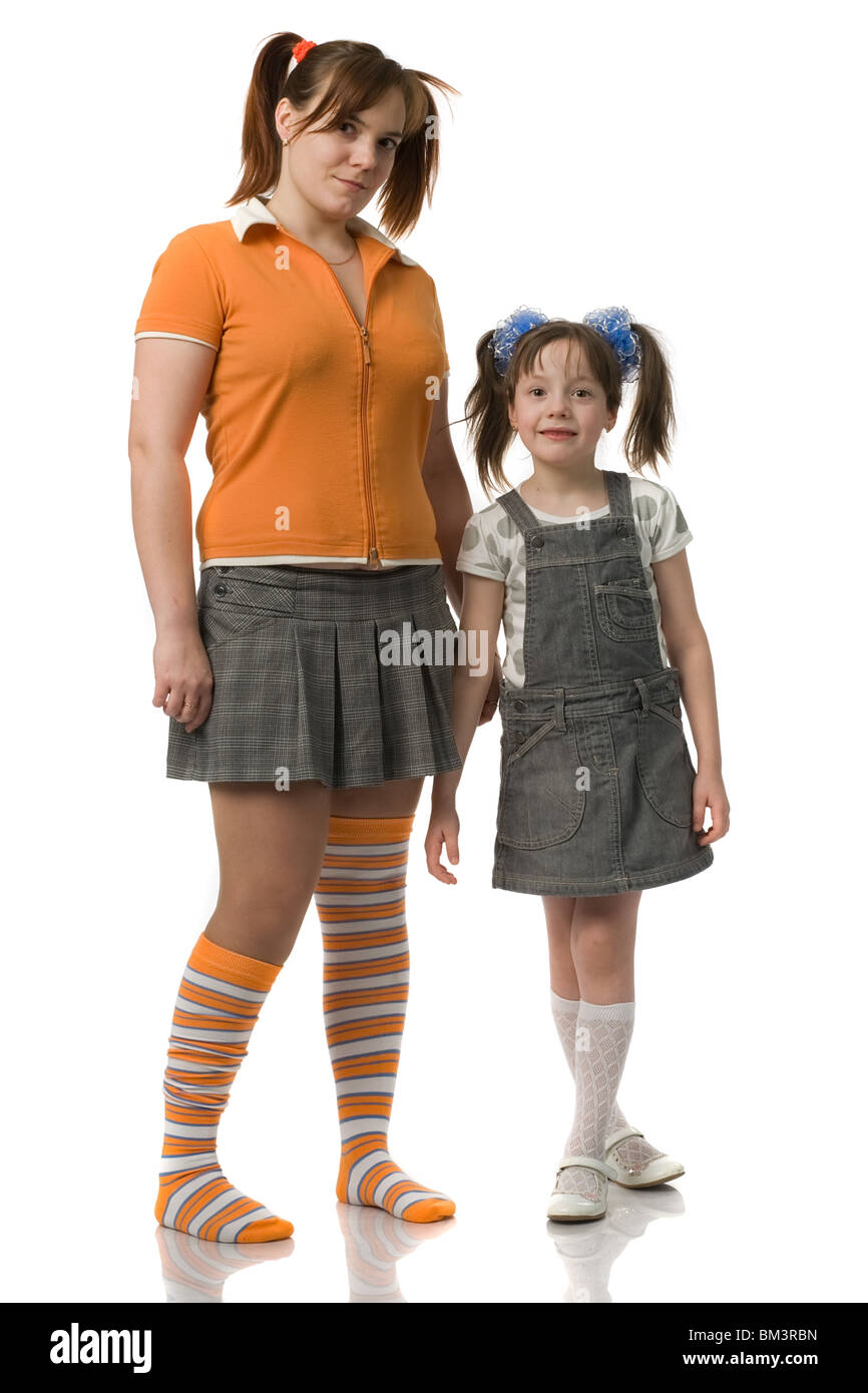 Mother and daughter with pony tails stand alongside , isolated on white Stock Photo