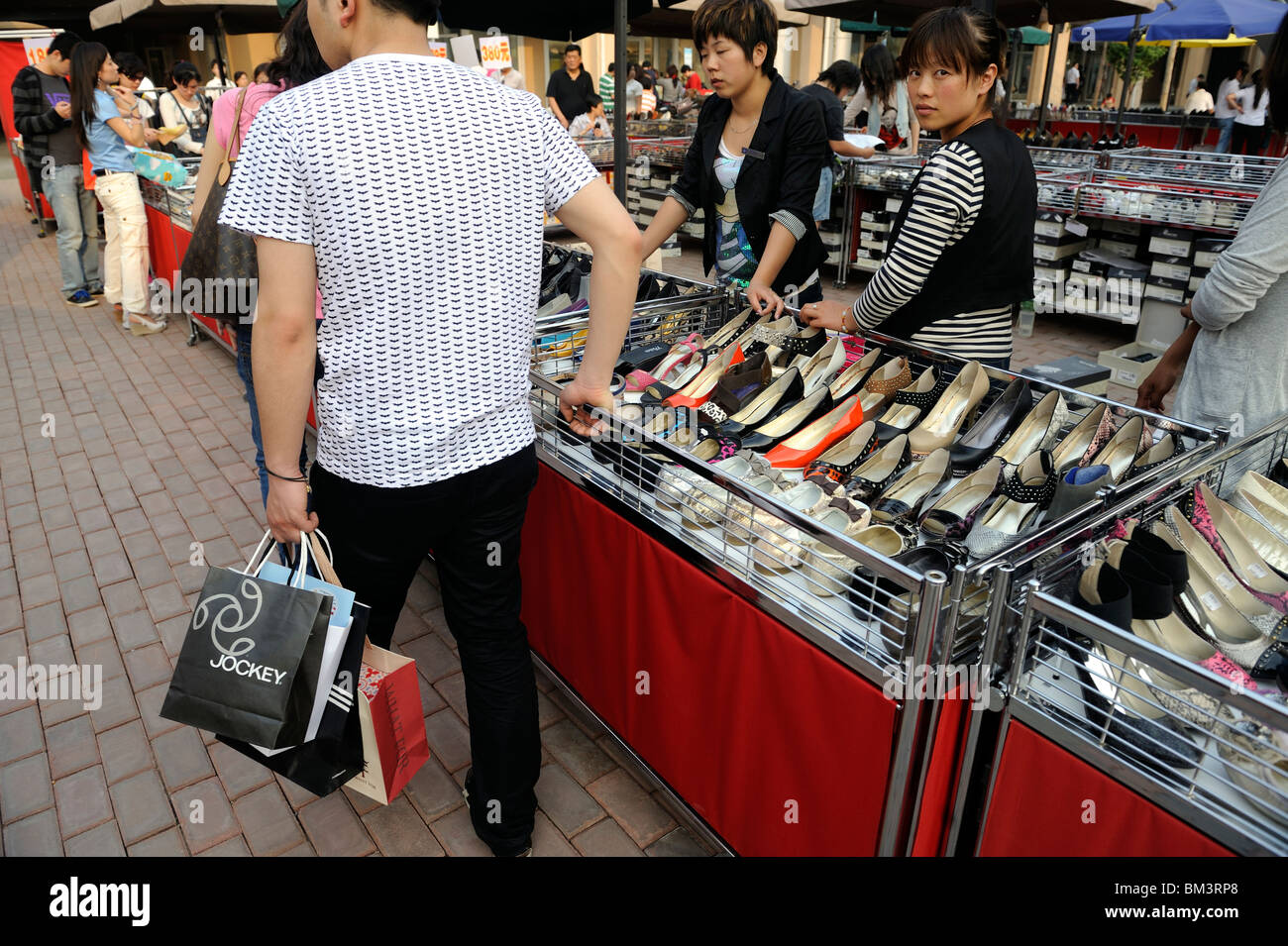 Two Chinese ladies carry Louis Vuitton handbags at Beijing Scitech Premium  Outlet Mall in Beijing, China. 15-May-2010 Stock Photo - Alamy