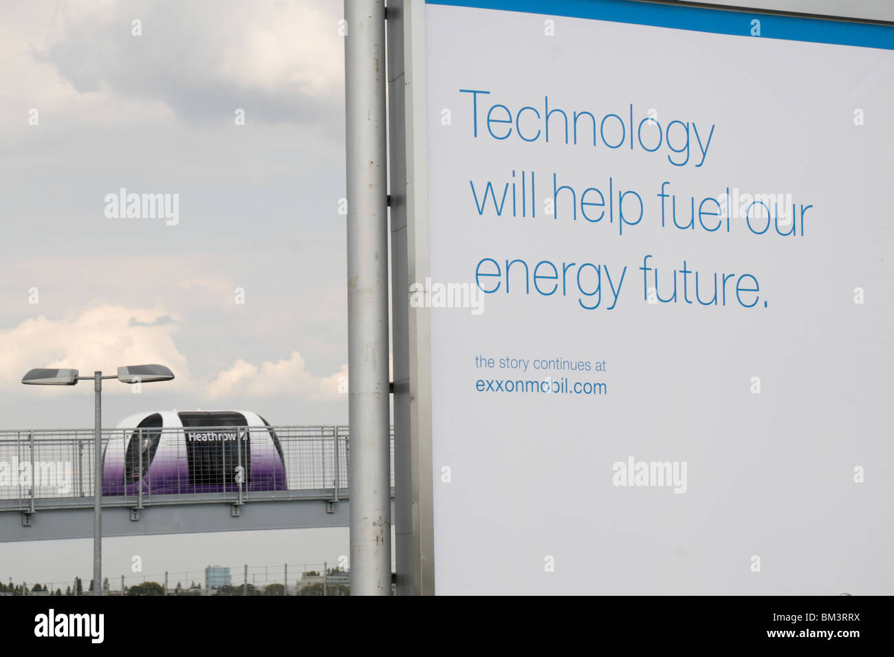 A Personal Rapid Transport (PRT) pod passes a poignant Exxon ad about the future benefit of technology to energy conservation. Stock Photo