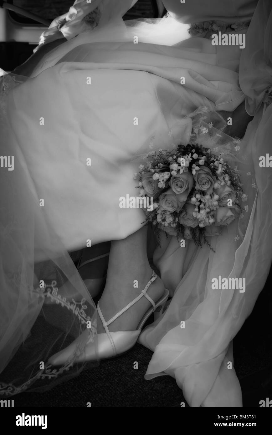 Bride with flowers bouquet inside a car Stock Photo