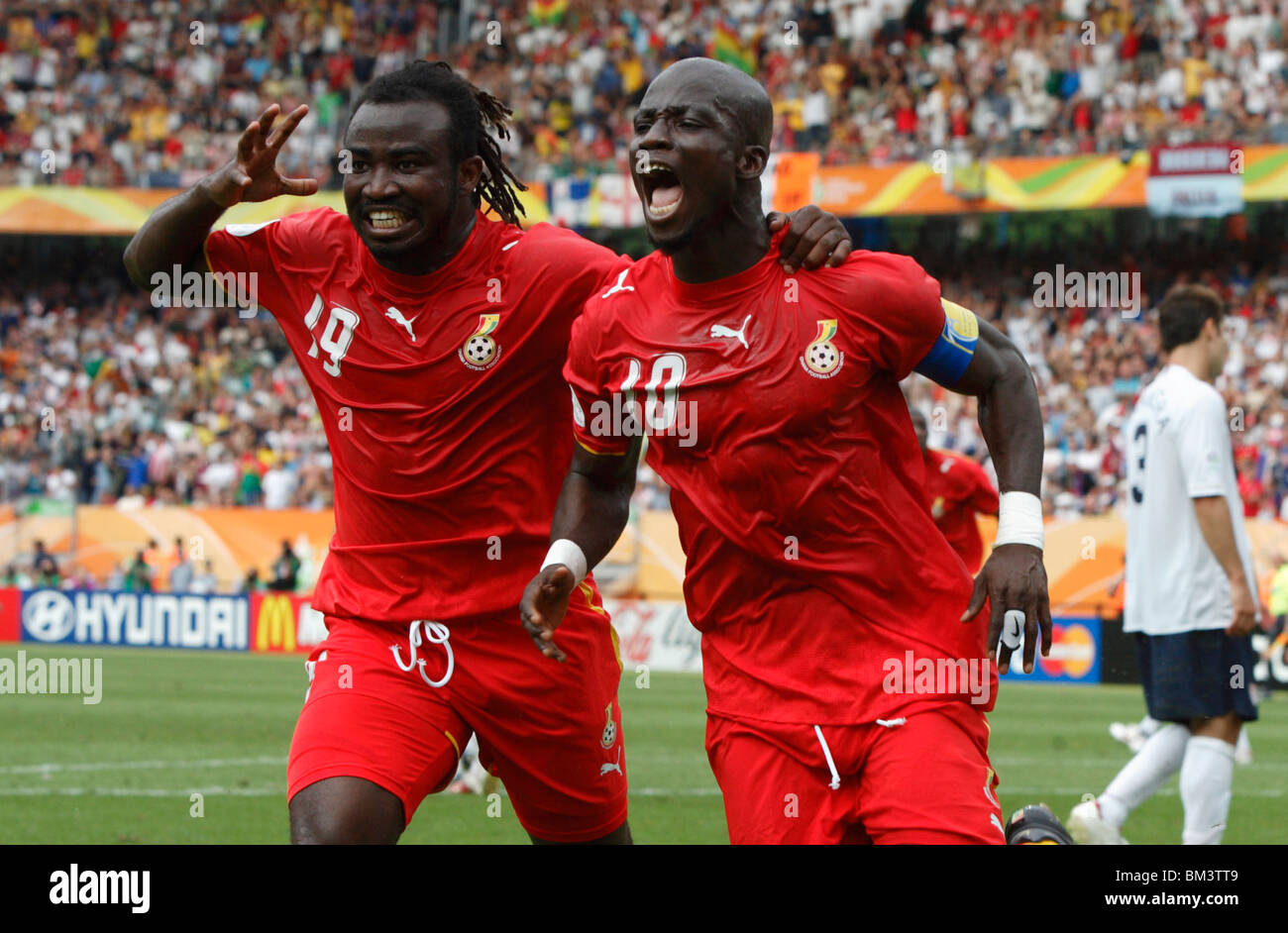 Ghanaian players Razak Pimpong (l) and Stephen Appiah (r) celebrate after Appiah scored a goal against the USA 2006 World Cup Stock Photo