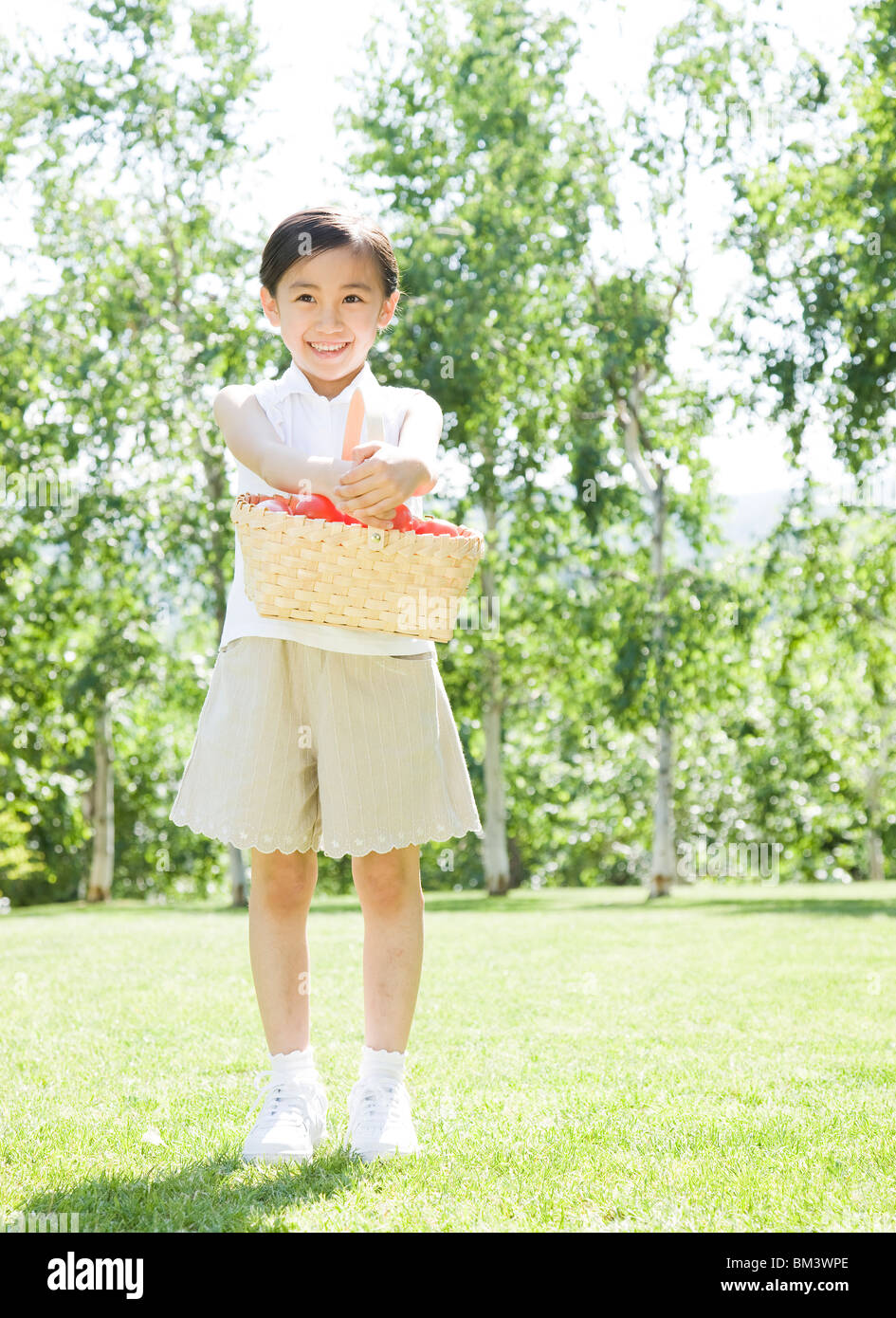 A Girl Holding Basket Stock Photo