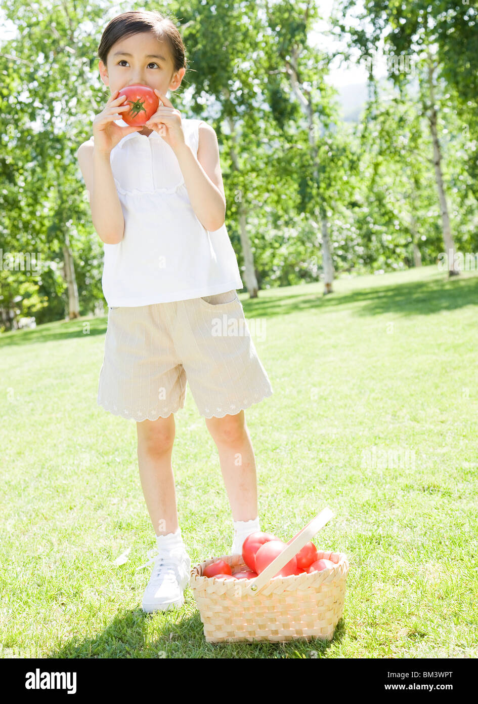 A Girl Holding Tomato Stock Photo - Alamy