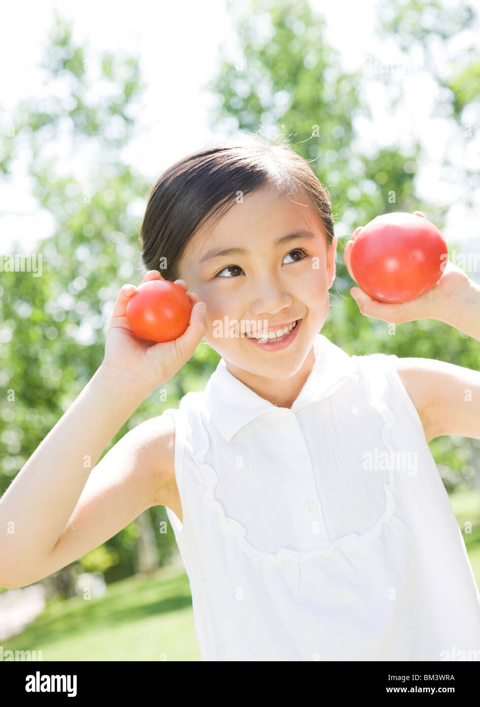 A Girl Holding Tomato Stock Photo - Alamy