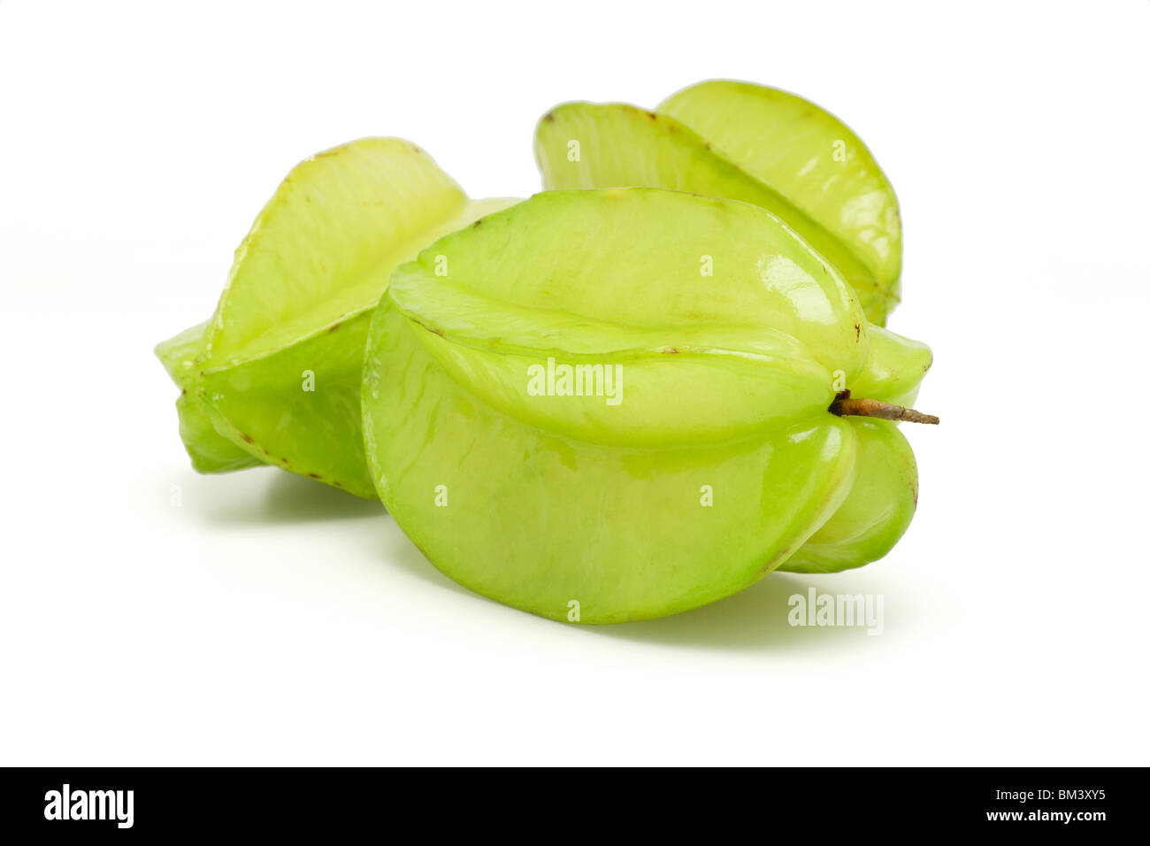 Three green star fruits on white background Stock Photo Alamy