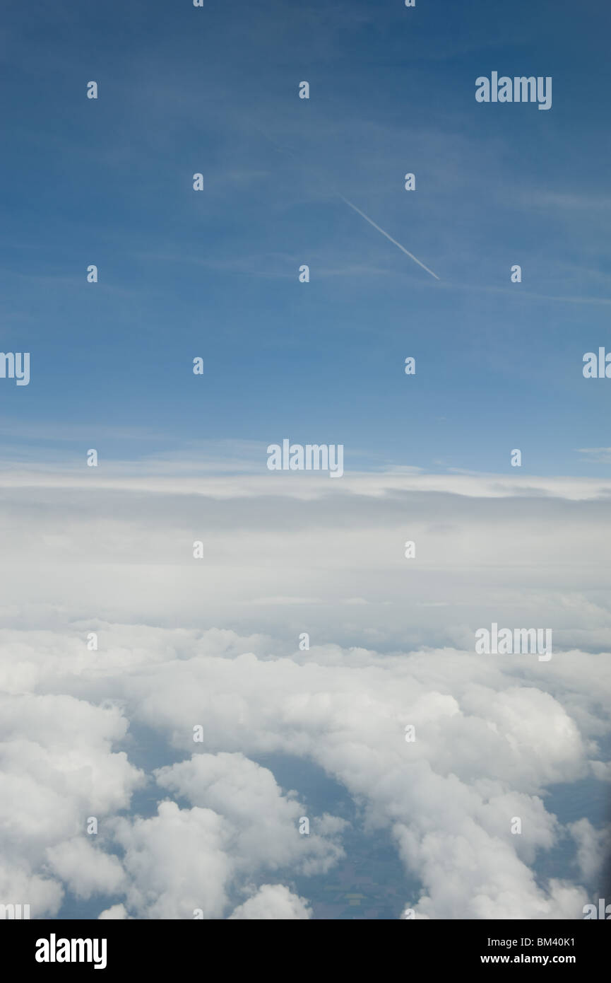View from a passenger plane's window with blue sky and clouds, 2010 Stock Photo
