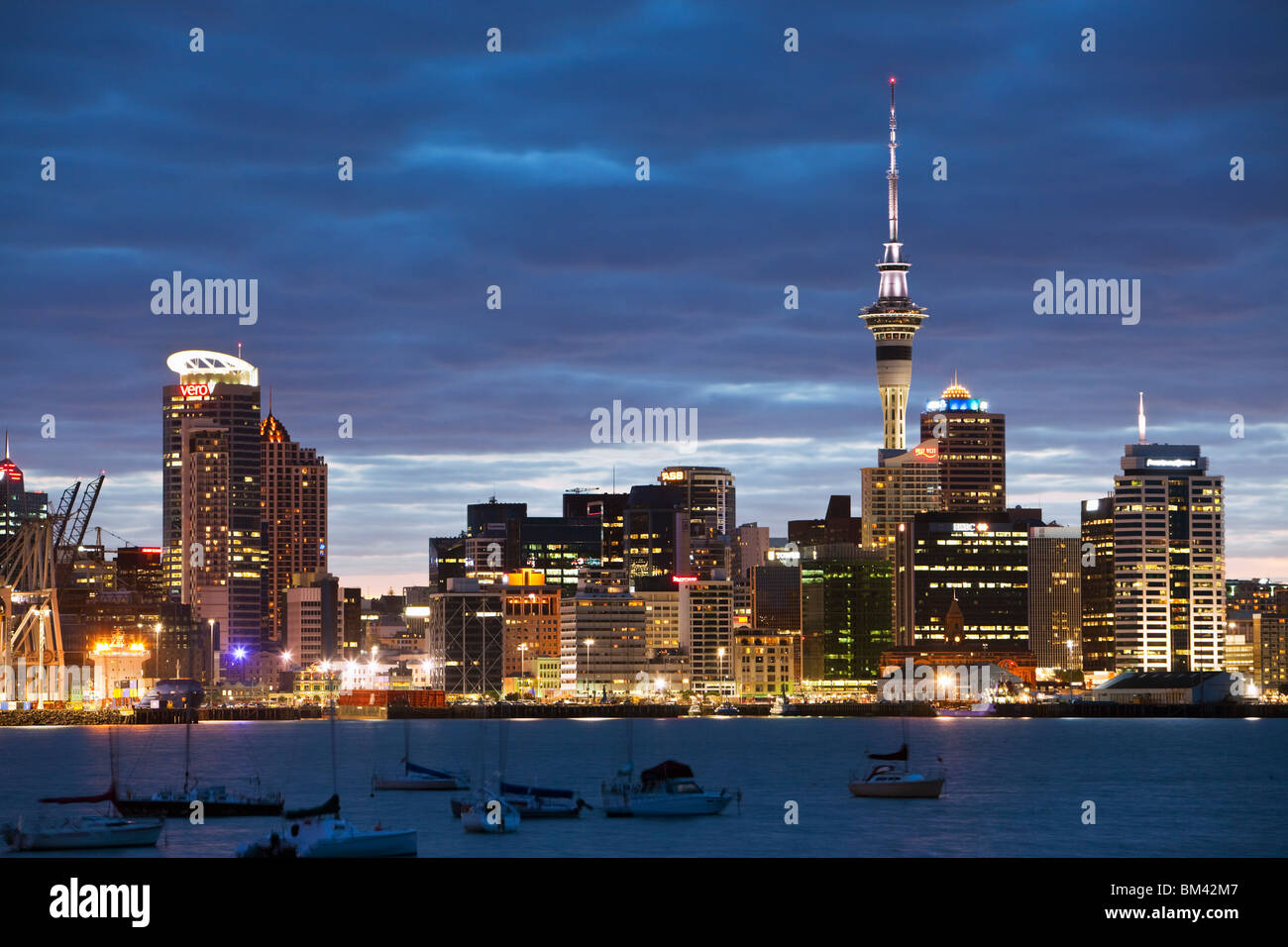 Auckland city skyline at dusk, viewed from Devenport.  Auckland, North Island, New Zealand Stock Photo