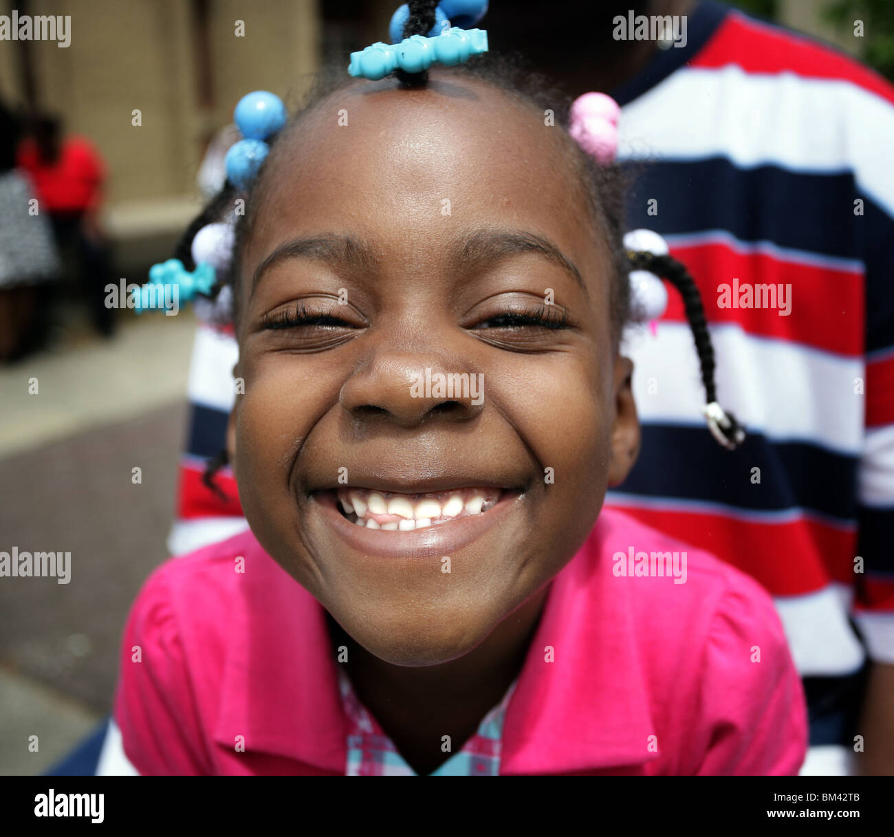 A cute 'African American' girl shows off her smile during a parade in New Haven CT USA Stock Photo