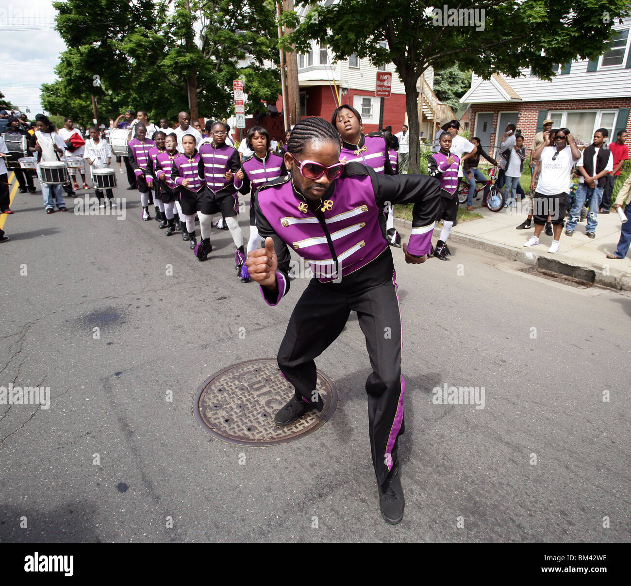 A drill team dances during the annual 'Freddie Fixer' parade in New Haven CT. The parade celebrates African American history Stock Photo