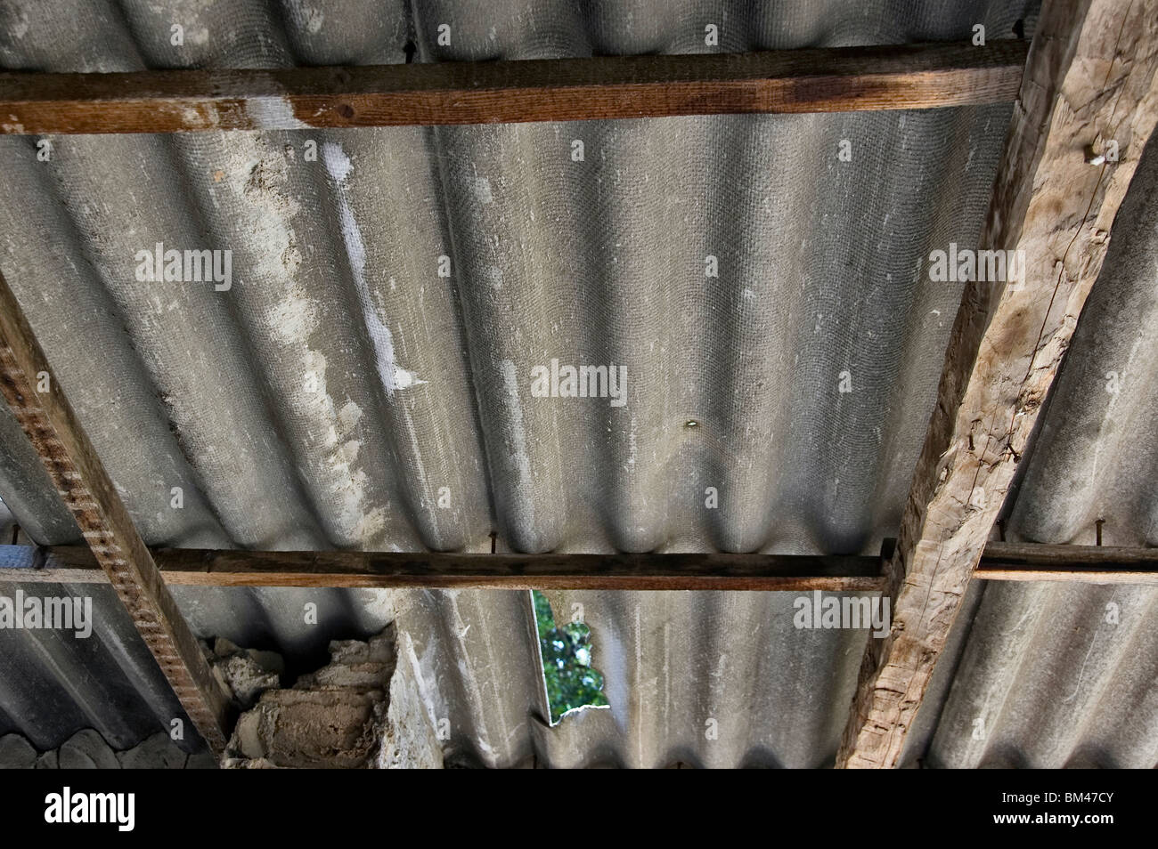 Broken asbestos roofing inside an abandoned house. Hazardous material