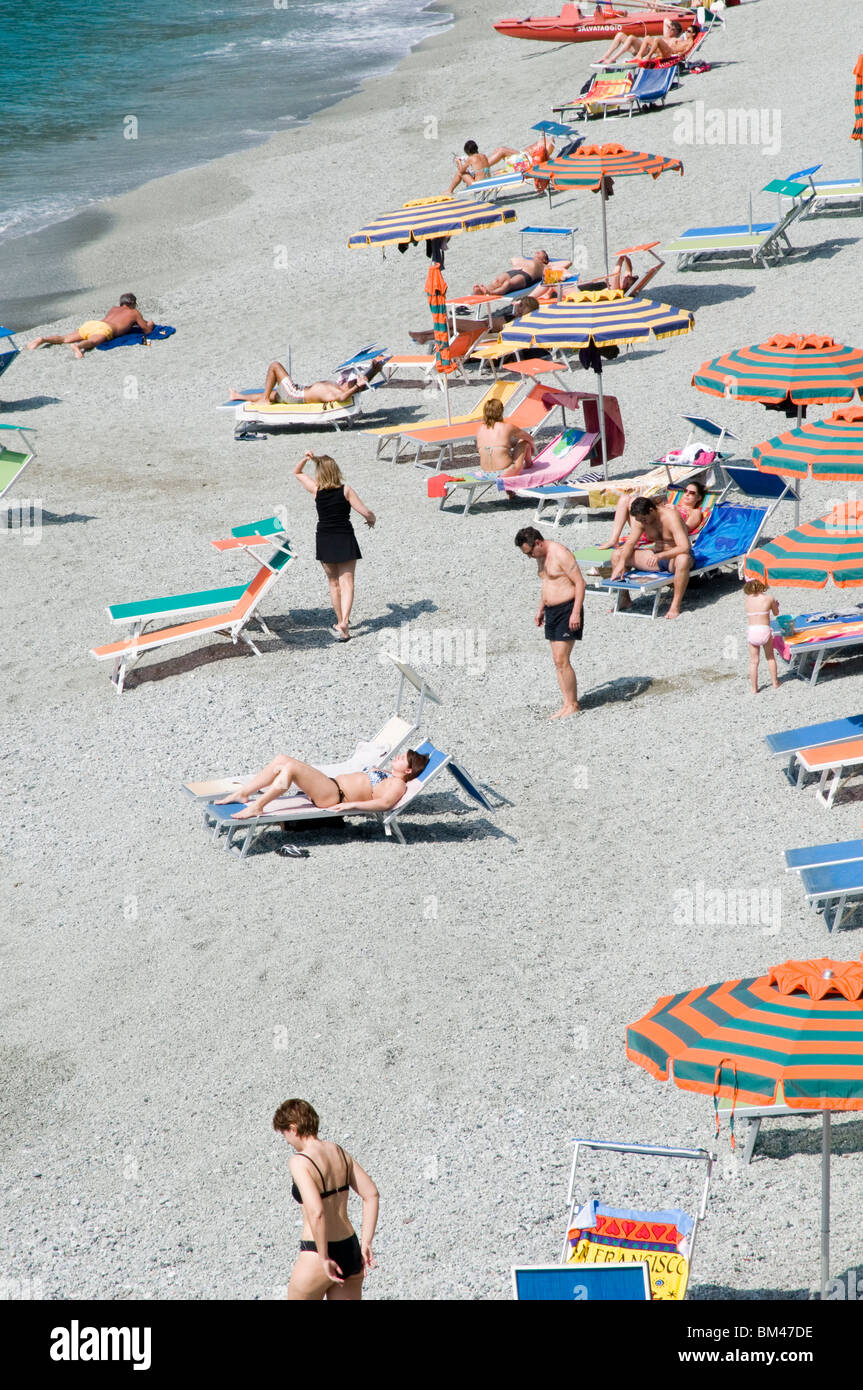 monterosso italy italian rivera beach beaches mediterranean sea resort resorts sunbathing bathers swimming in swimmers blue seas Stock Photo