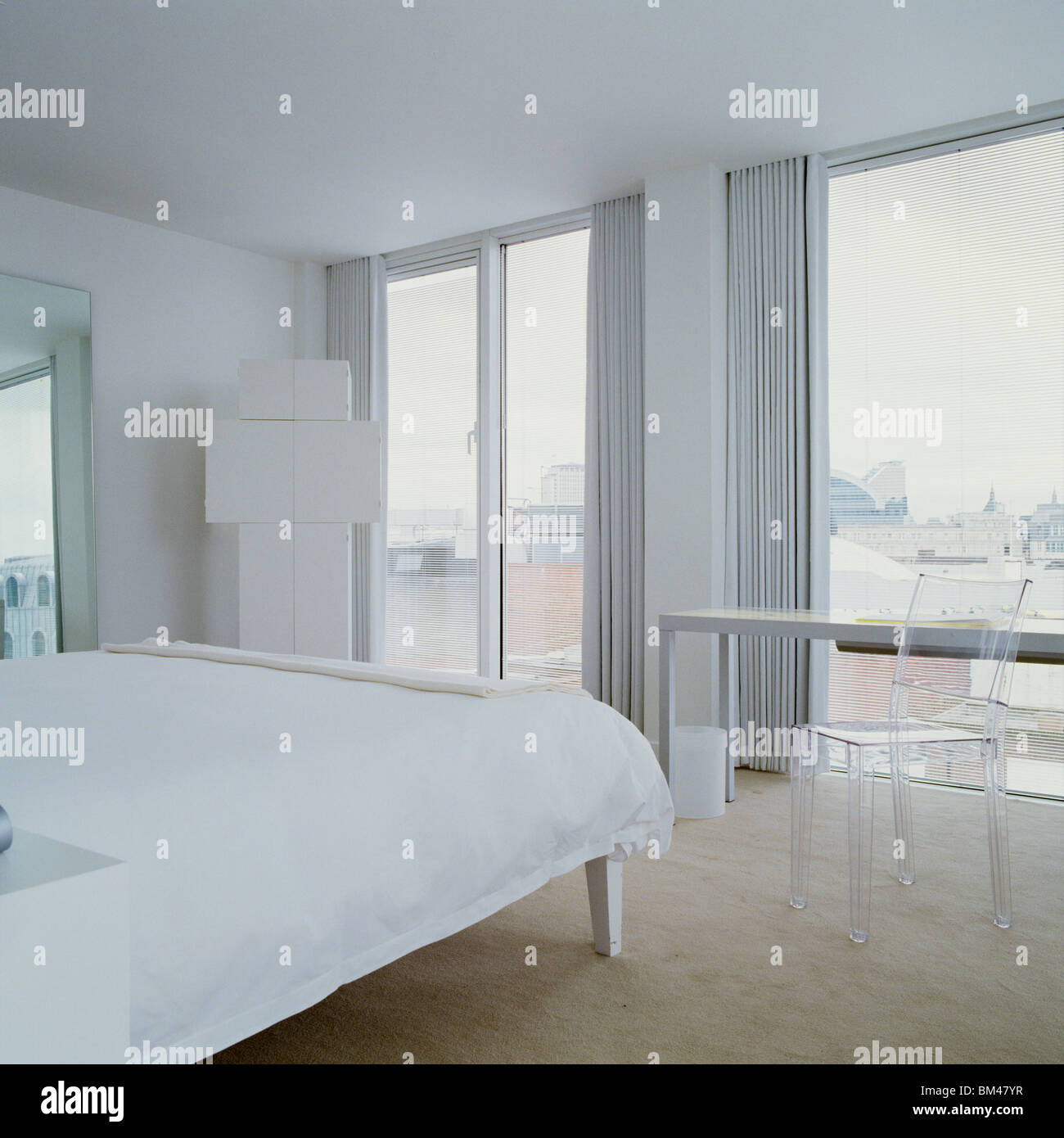 White minimalist hotel bedroom and window designed by Philippe Starck, St Martins Lane hotel, London Stock Photo