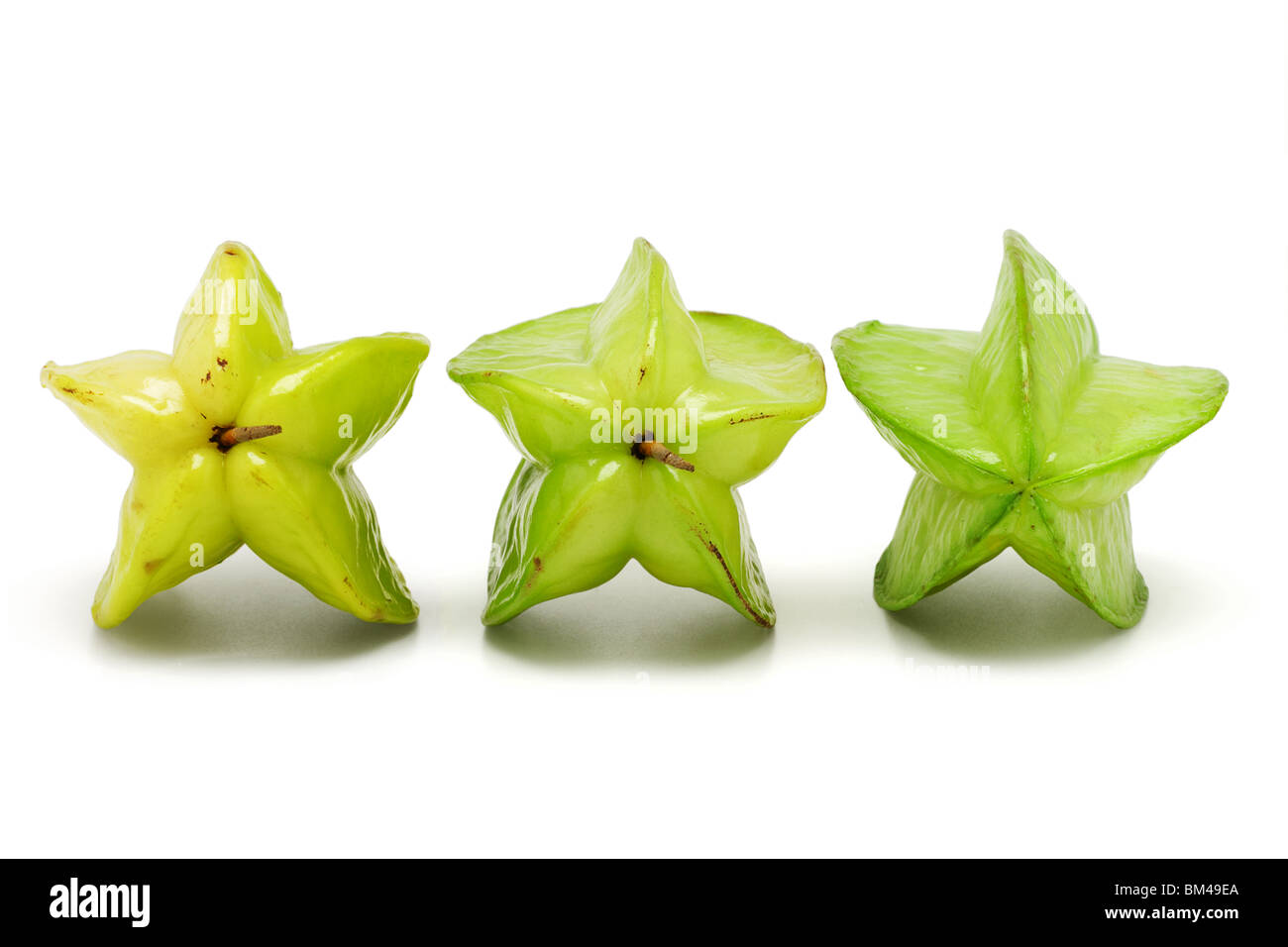 Star Ripe Produce Transit Ripening System Three ripening star fruits on white background Stock Photo - Alamy