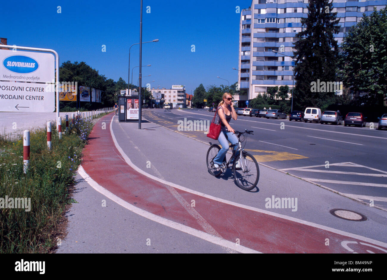Ljubljana, Slovenia, 15 June 2009 -- Cyclist talking on cell phone. Stock Photo