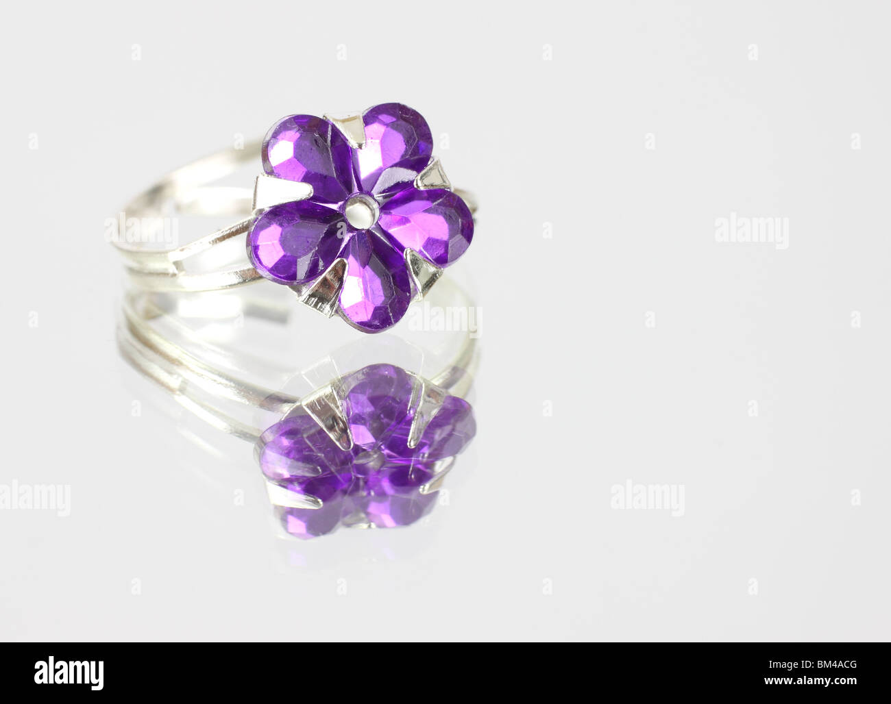 Costume jewelry ring on mirrored surface Stock Photo