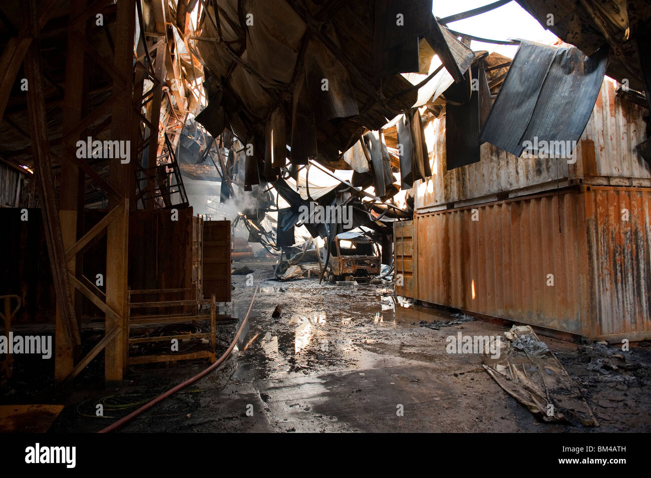 Large factory and warehouse collapsed and smoldering following major ...
